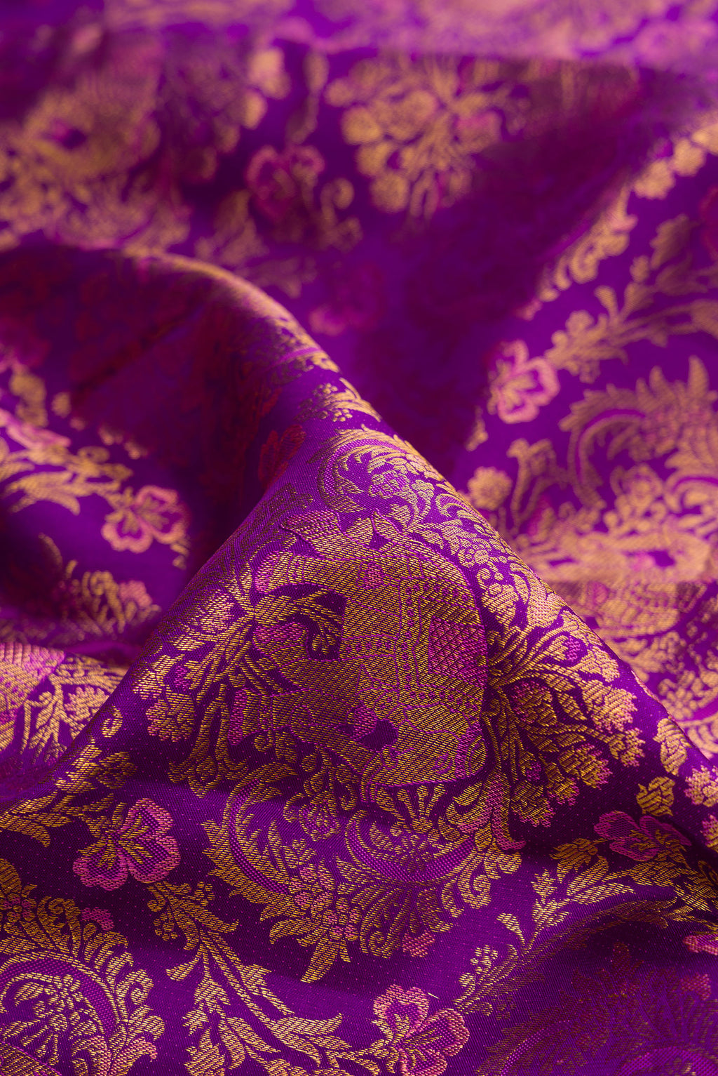 Close up of Purple Kanjivaram Silk Saree with Zari Brocade on the body and Zari Border.  displaying folds