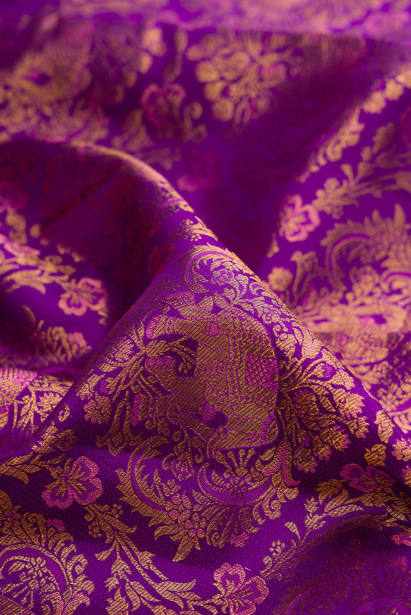 Close up of Purple Kanjivaram Silk Saree with Zari Brocade on the body and Zari Border.  displaying folds