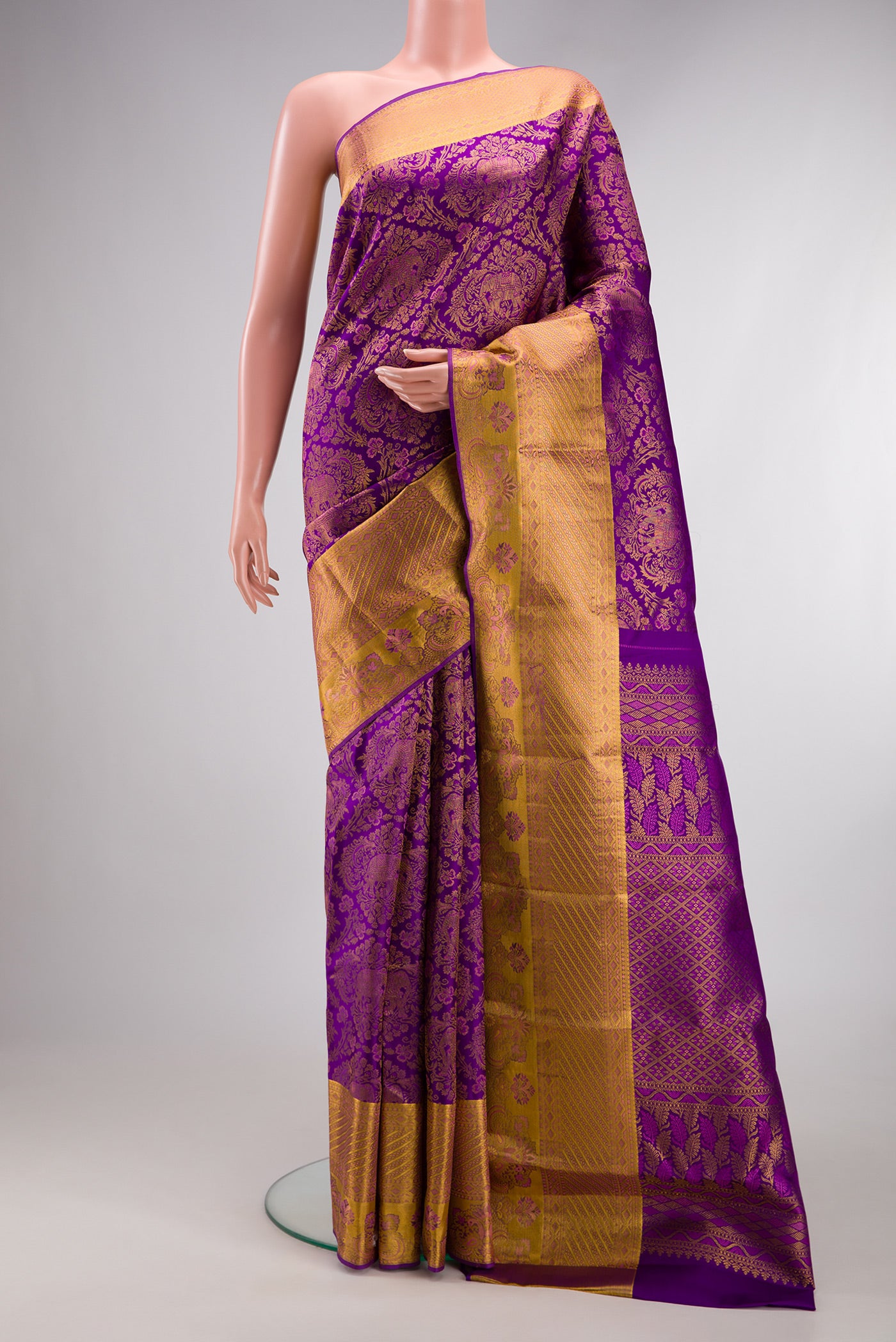 Purple Kanjivaram Silk Saree with Zari Brocade on the body and Zari Border.  displayed on a mannequin