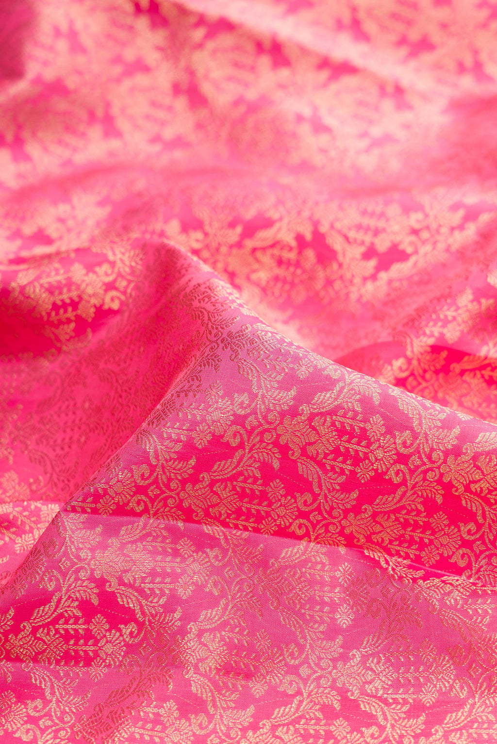 Close up of Pure Silk Rose pink Kanjivaram Saree with Zari Brocade on the body and Fancy Border.  displaying folds
