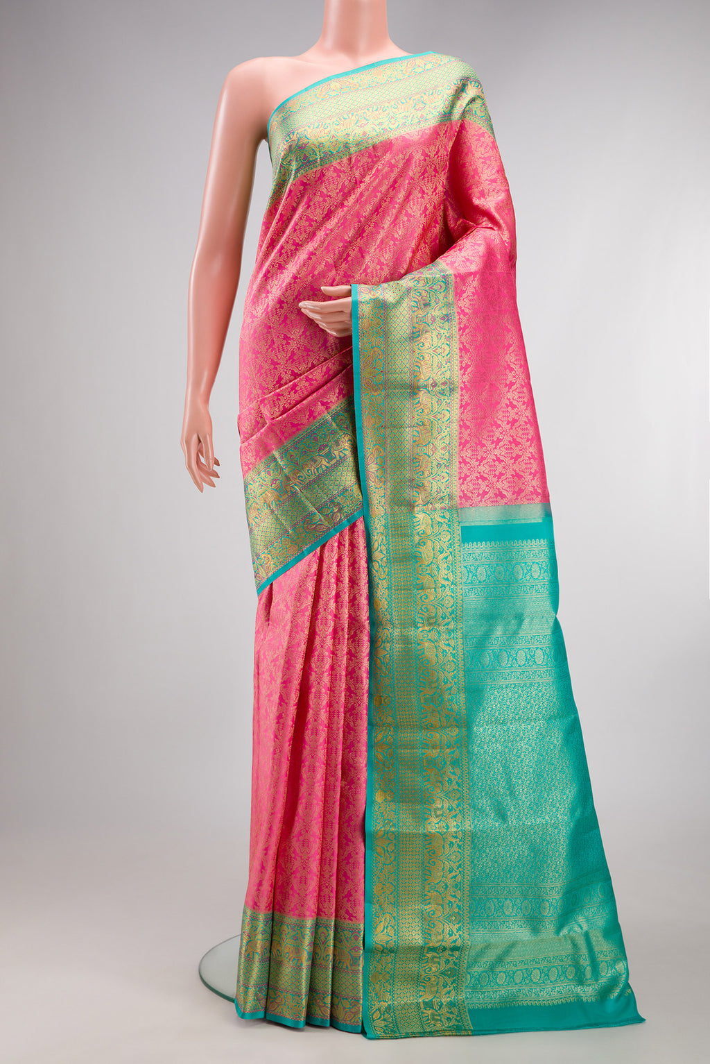 Pure Silk Rose pink Kanjivaram Saree with Zari Brocade on the body and Fancy Border.  displayed on a mannequin