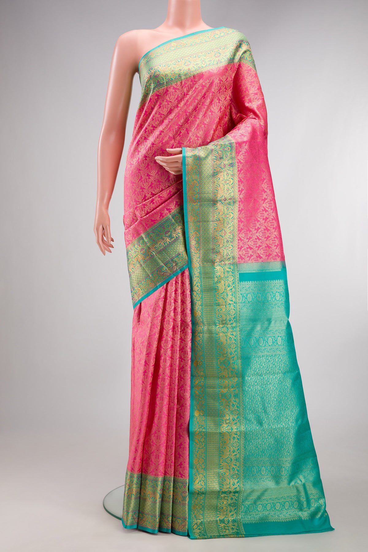 Pure Silk Rose pink Kanjivaram Saree with Zari Brocade on the body and Fancy Border.  displayed on a mannequin