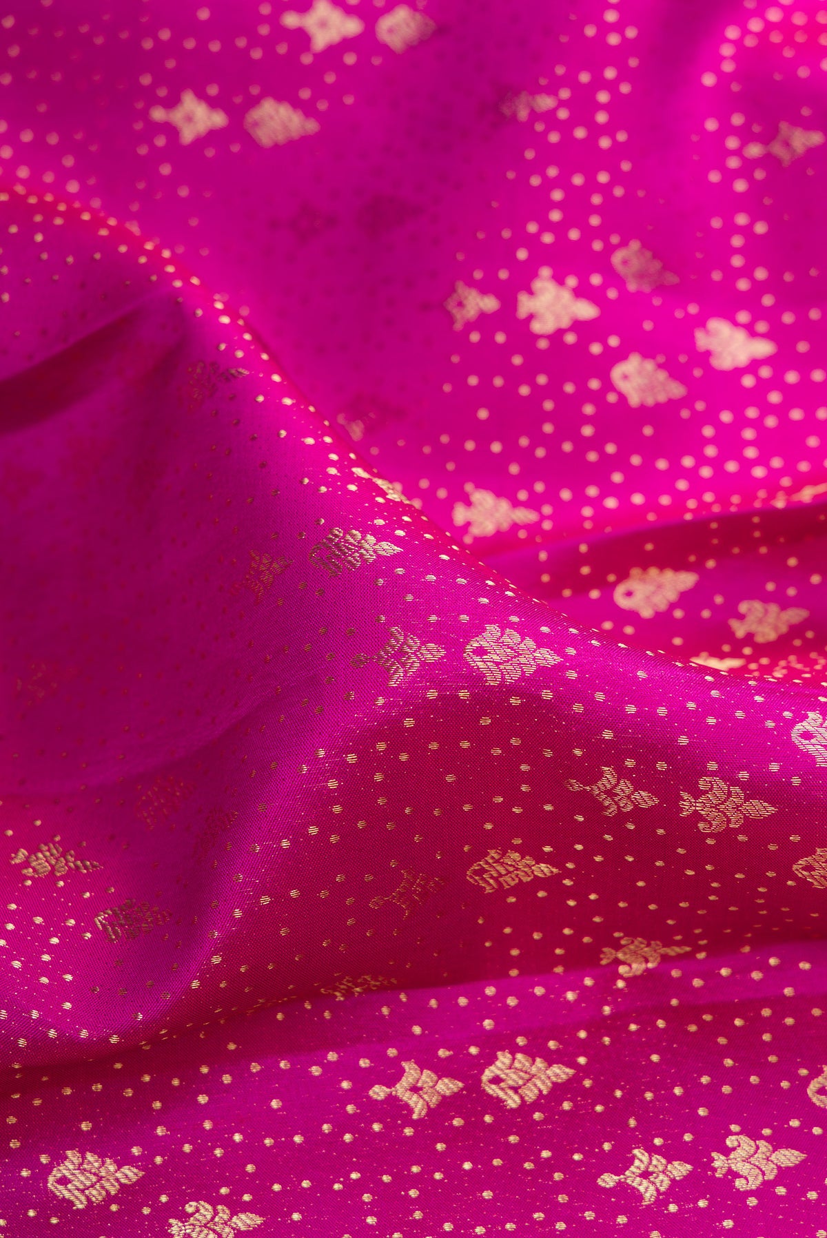 Close up of Pure Silk Magenta Kanchipuram Saree with Zari Brocade on the body and Fancy Border.  displaying folds