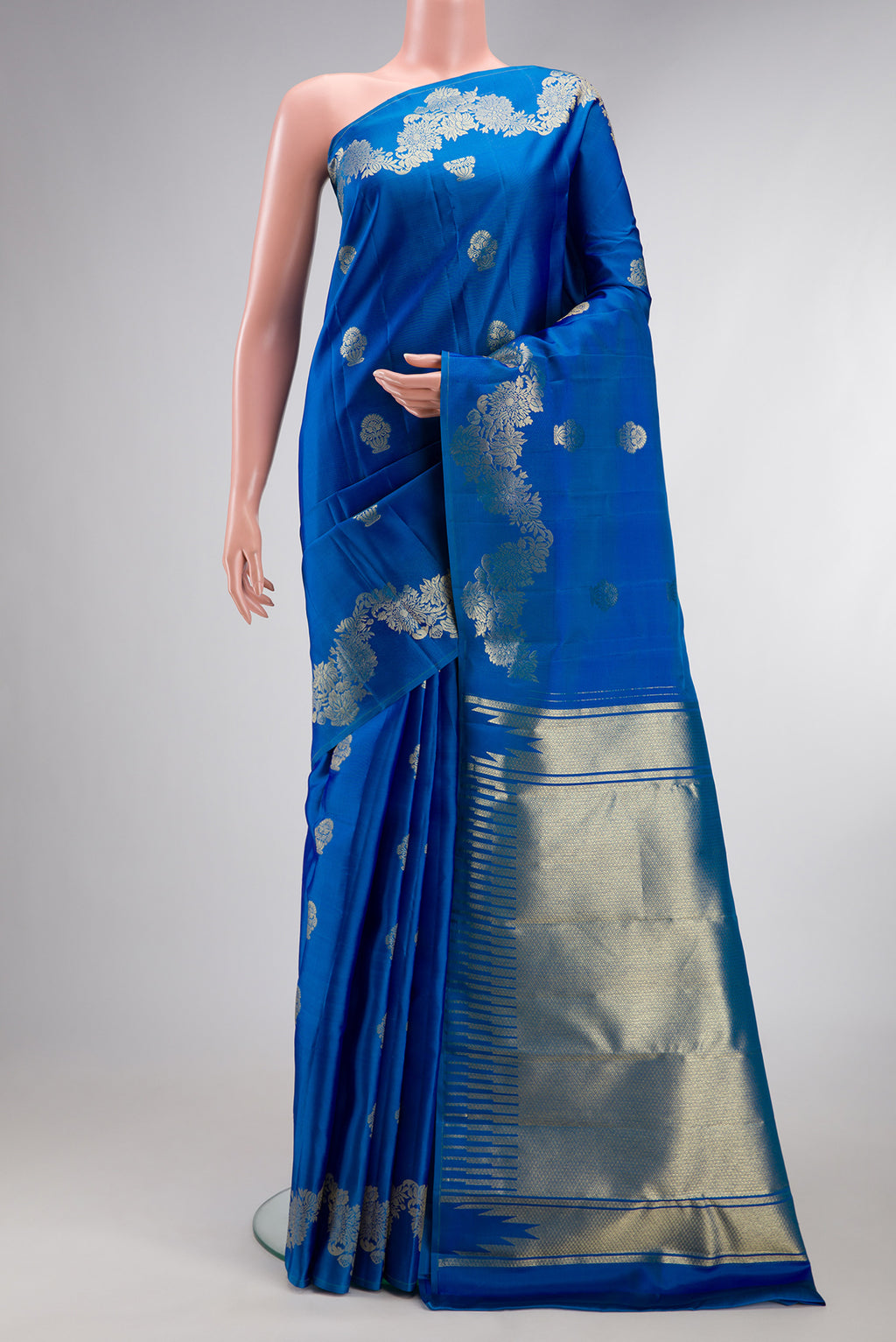 Pure Silk Peacock Blue Kanchipuram Saree with Zari Butta on the body and Fancy Border.  displayed on a mannequin