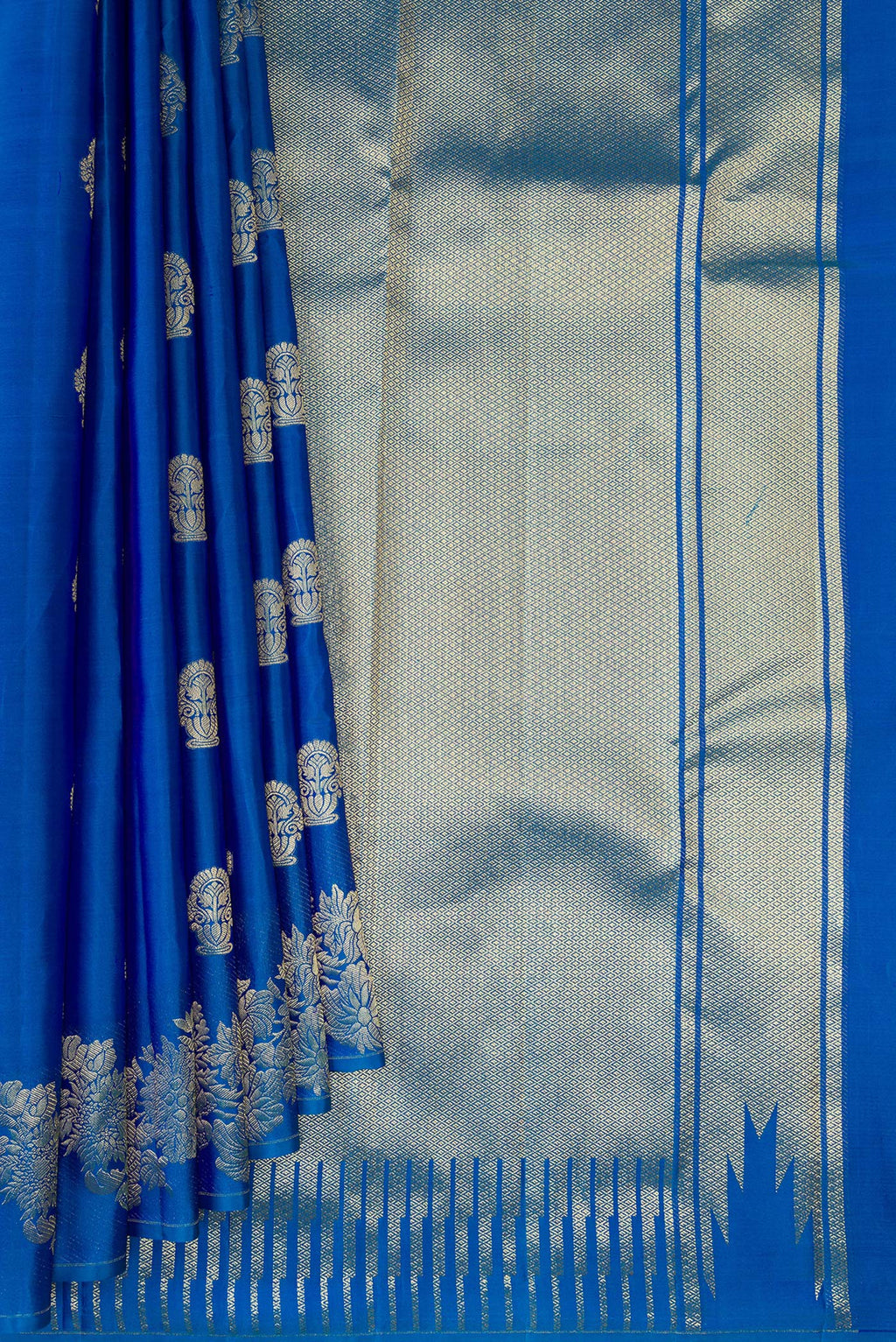 Pleats and pallu of Pure Silk Peacock Blue Kanchipuram Saree with Zari Butta on the body and Fancy Border. 