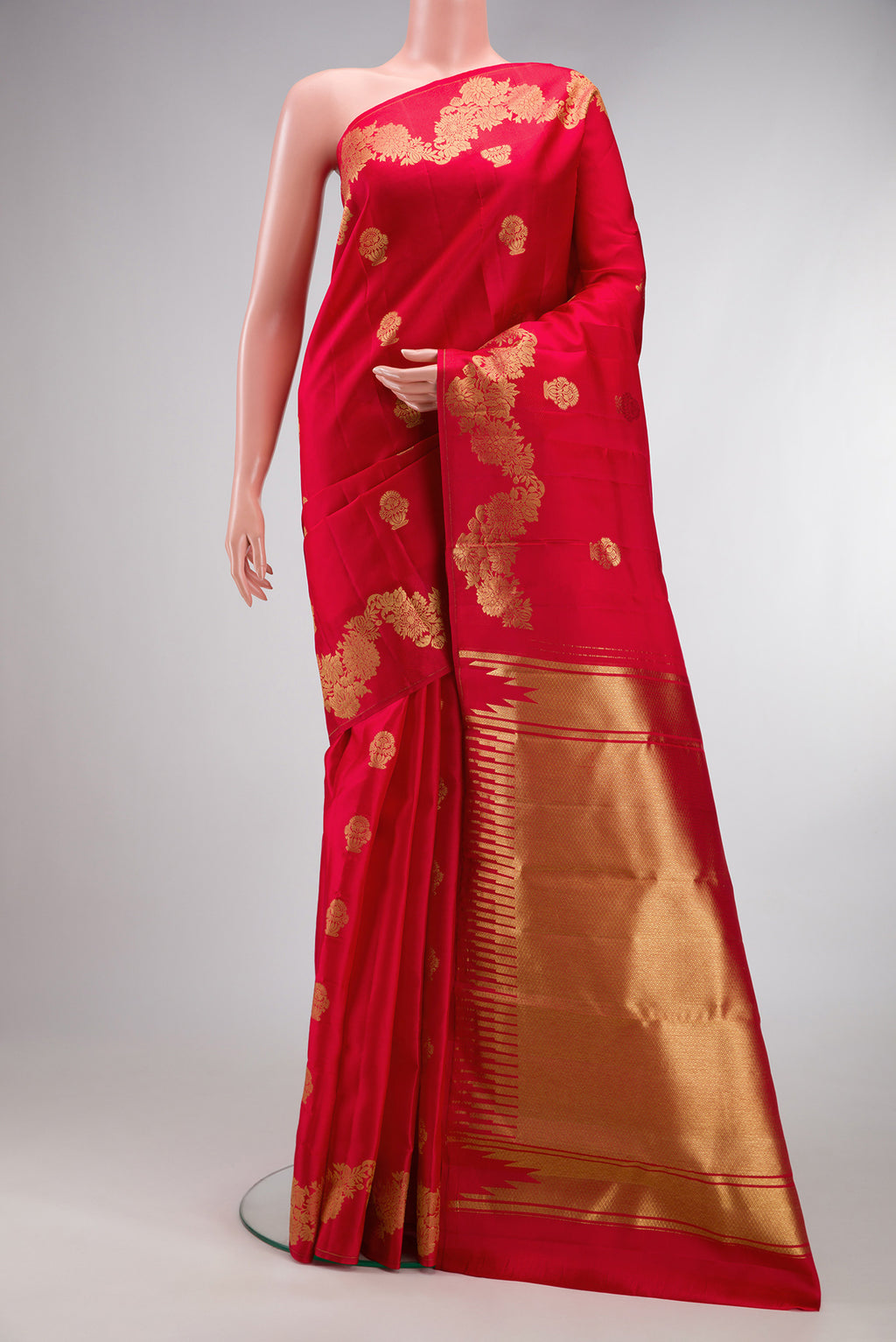 Red Kanchipuram Silk Saree with Zari Butta on the body and Fancy Border.  displayed on a mannequin