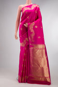Pure Silk Rani Pink Kanchipuram Saree with Zari Butta on the body and Fancy Border.  displayed on a mannequin