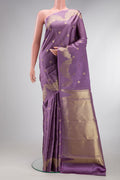 Lavender Kanchipuram Silk Saree with Zari Butta on the body and Fancy Border.  displayed on a mannequin