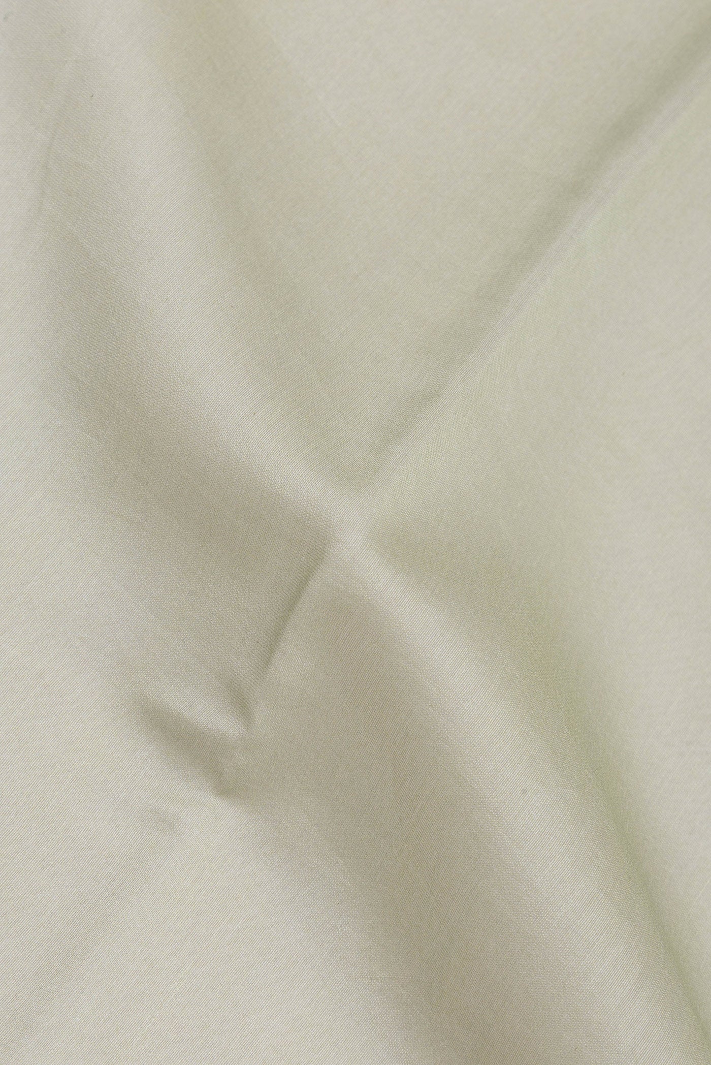 Close up of Pista Green Chanderi Silk Cotton Saree with Plain Body and Zari Border.  displaying folds