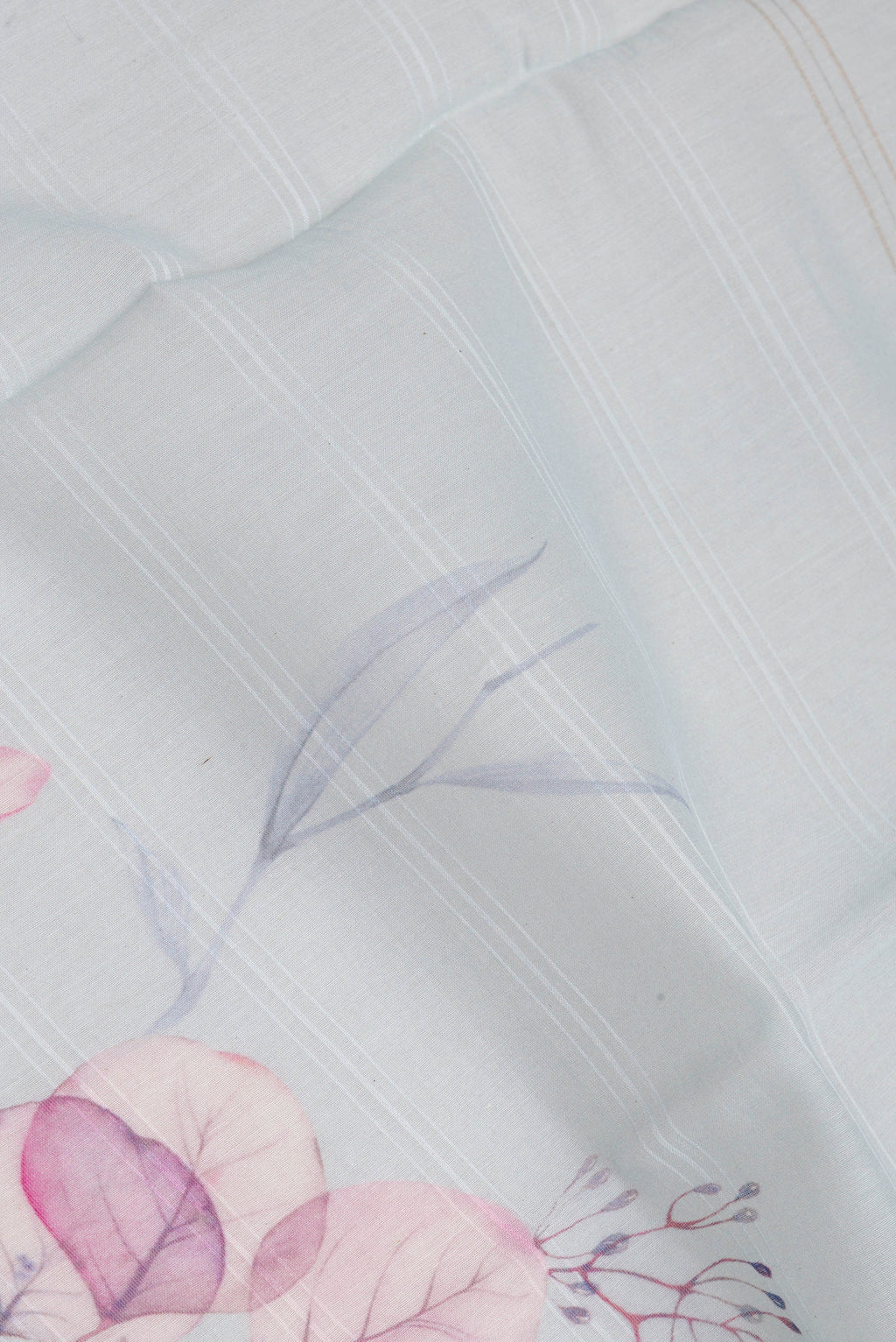 Close up of Light Blue Chanderi Silk Cotton Saree with Printed design on the body and Zari Border.  displaying folds