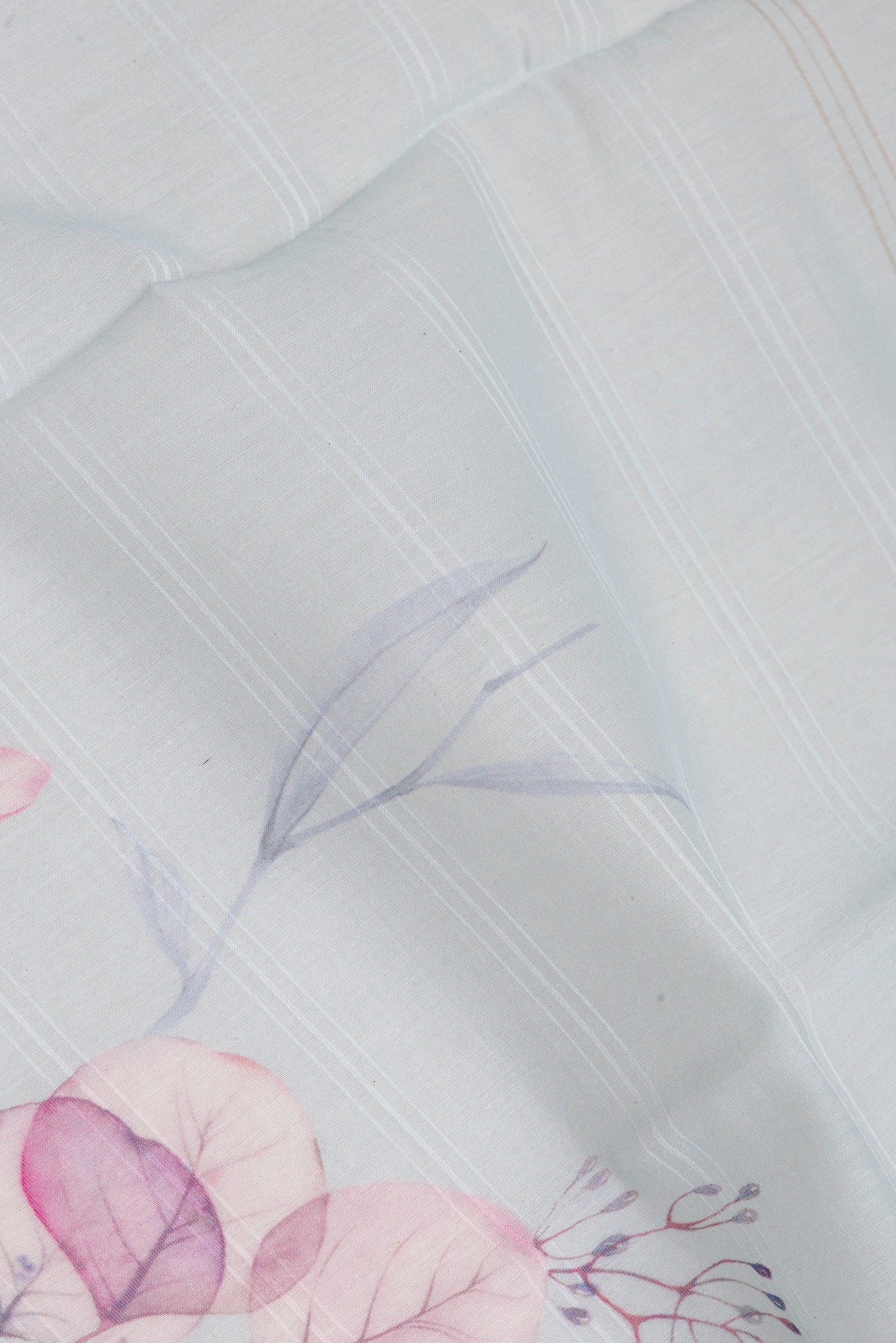 Close up of Light Blue Chanderi Silk Cotton Saree with Printed design on the body and Zari Border.  displaying folds
