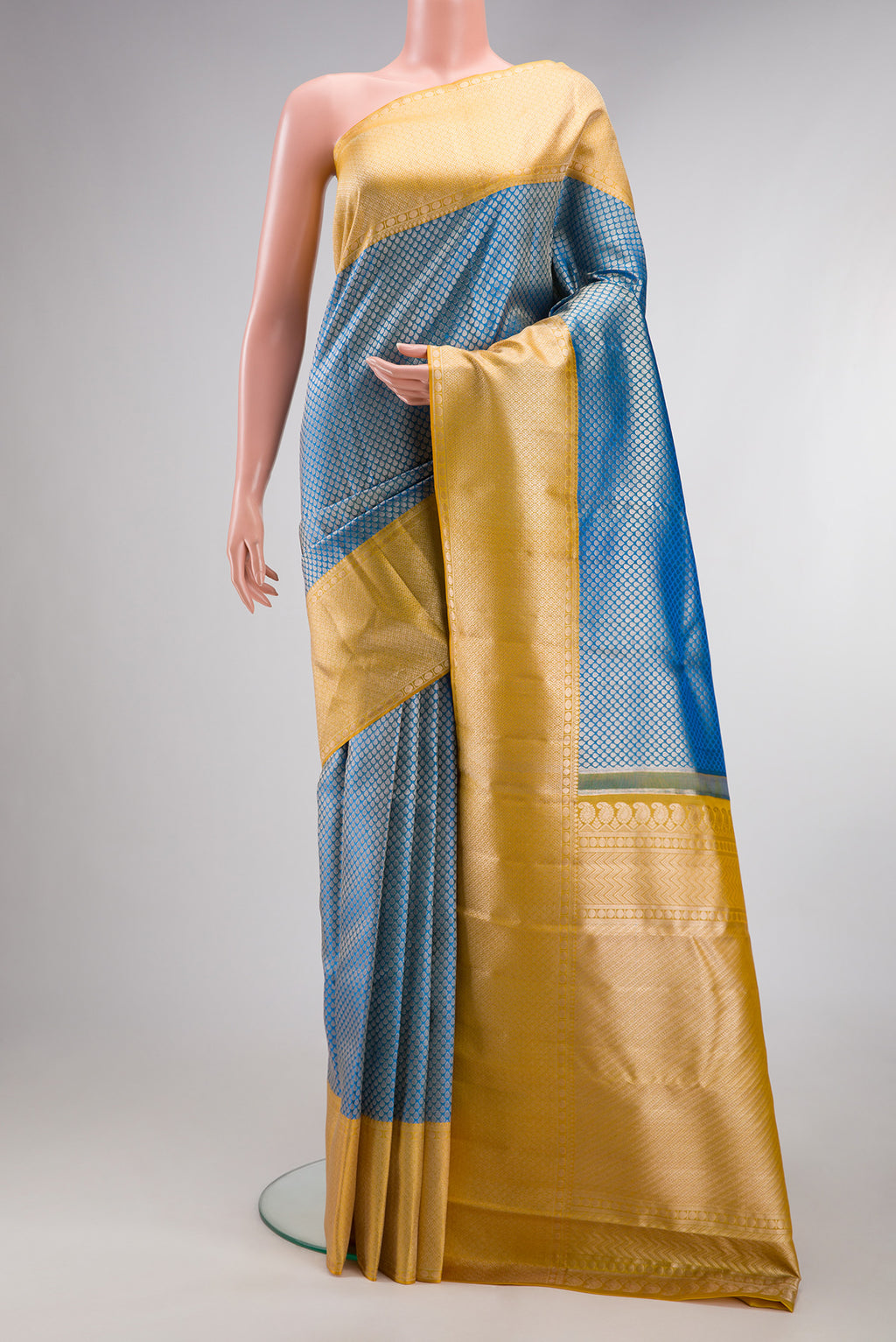 Pure Silk Peacock Blue Kanchipuram Tissue Saree with Zari Brocade on the body and Fancy Border.  displayed on a mannequin