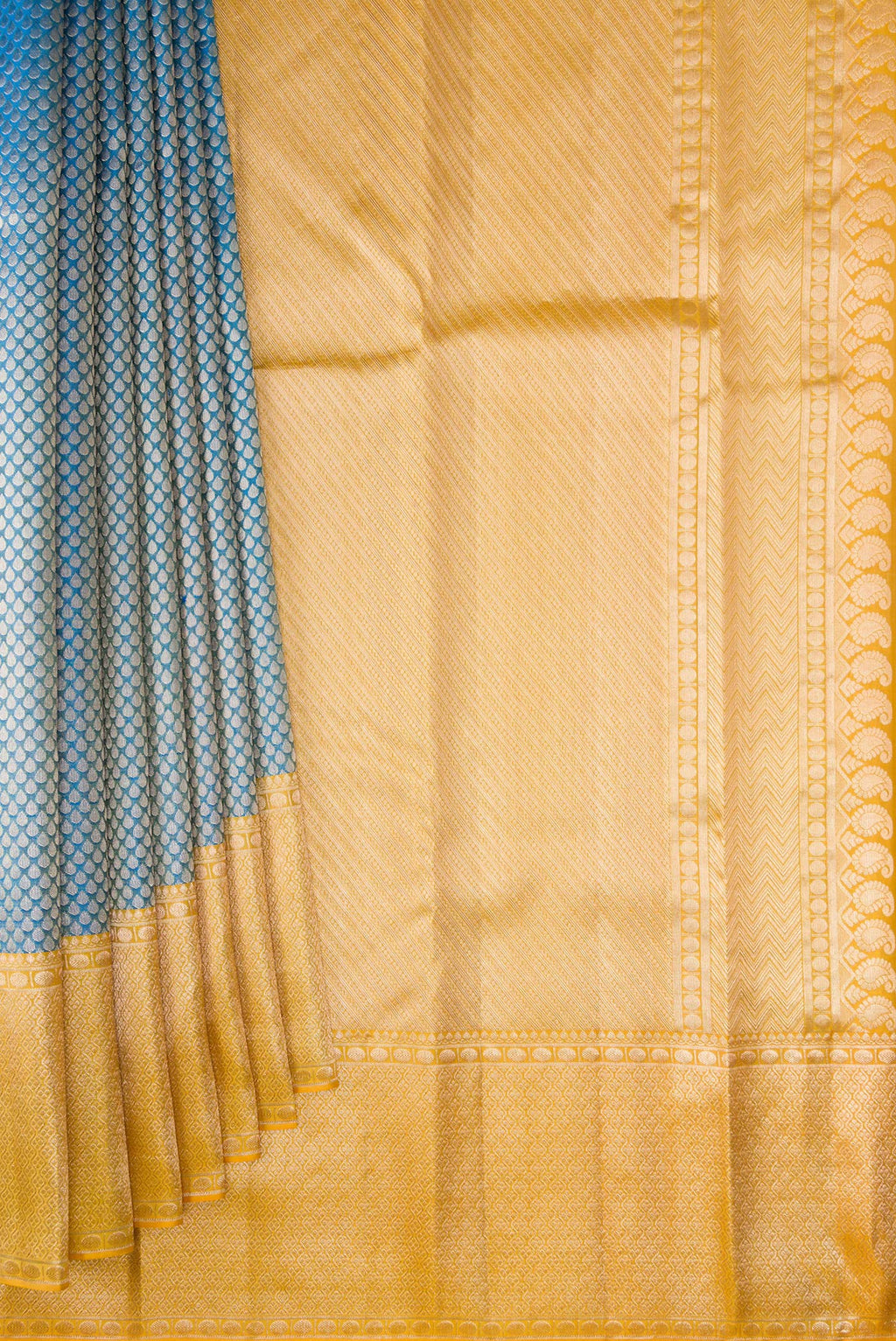 Pleats and pallu of Pure Silk Peacock Blue Kanchipuram Tissue Saree with Zari Brocade on the body and Fancy Border. 