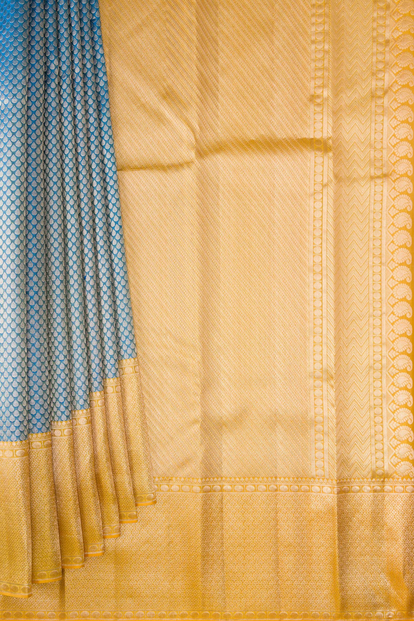 Pleats and pallu of Pure Silk Peacock Blue Kanchipuram Tissue Saree with Zari Brocade on the body and Fancy Border. 