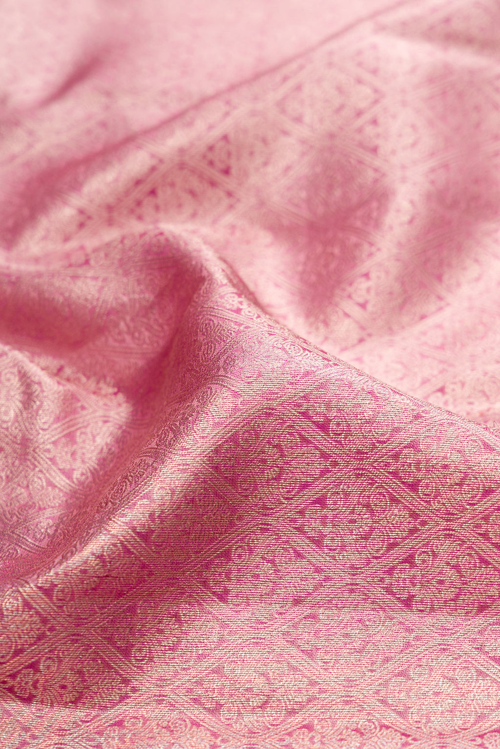 Close up of Rose pink Dual Tone Kanchipuram Tissue Silk Saree with Zari Brocade on the body and Fancy Border.  displaying folds