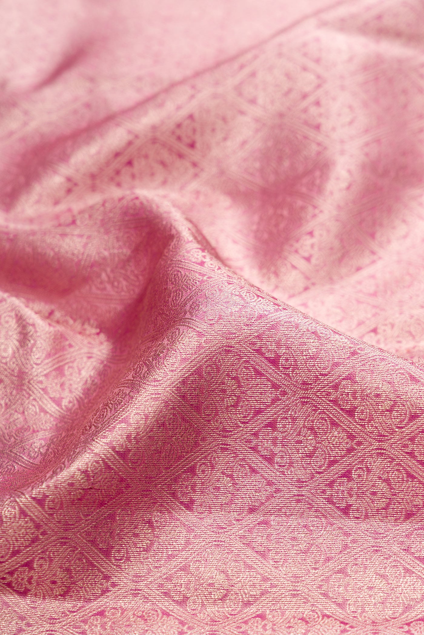 Close up of Rose pink Dual Tone Kanchipuram Tissue Silk Saree with Zari Brocade on the body and Fancy Border.  displaying folds