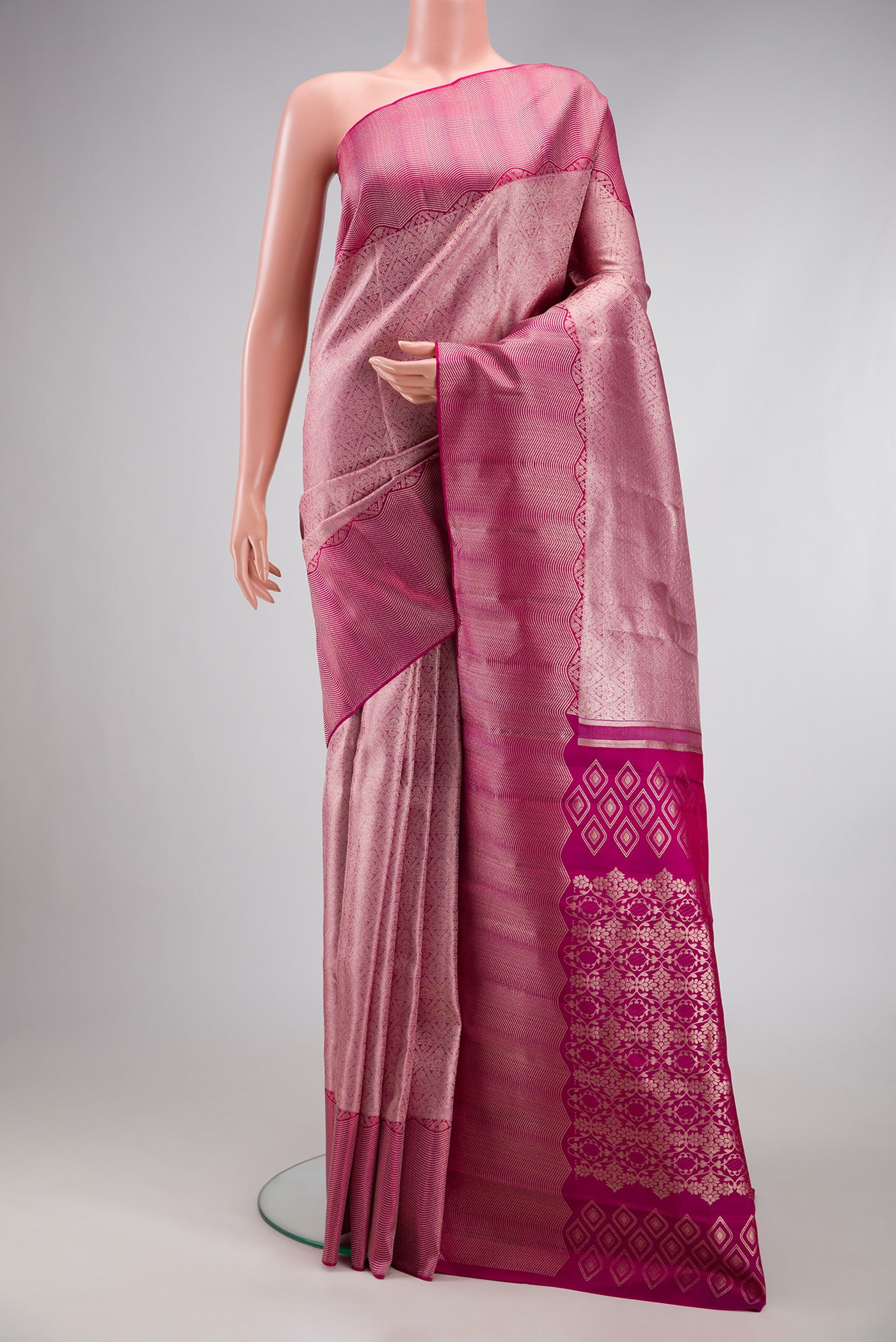 Rose pink Dual Tone Kanchipuram Tissue Silk Saree with Zari Brocade on the body and Fancy Border.  displayed on a mannequin