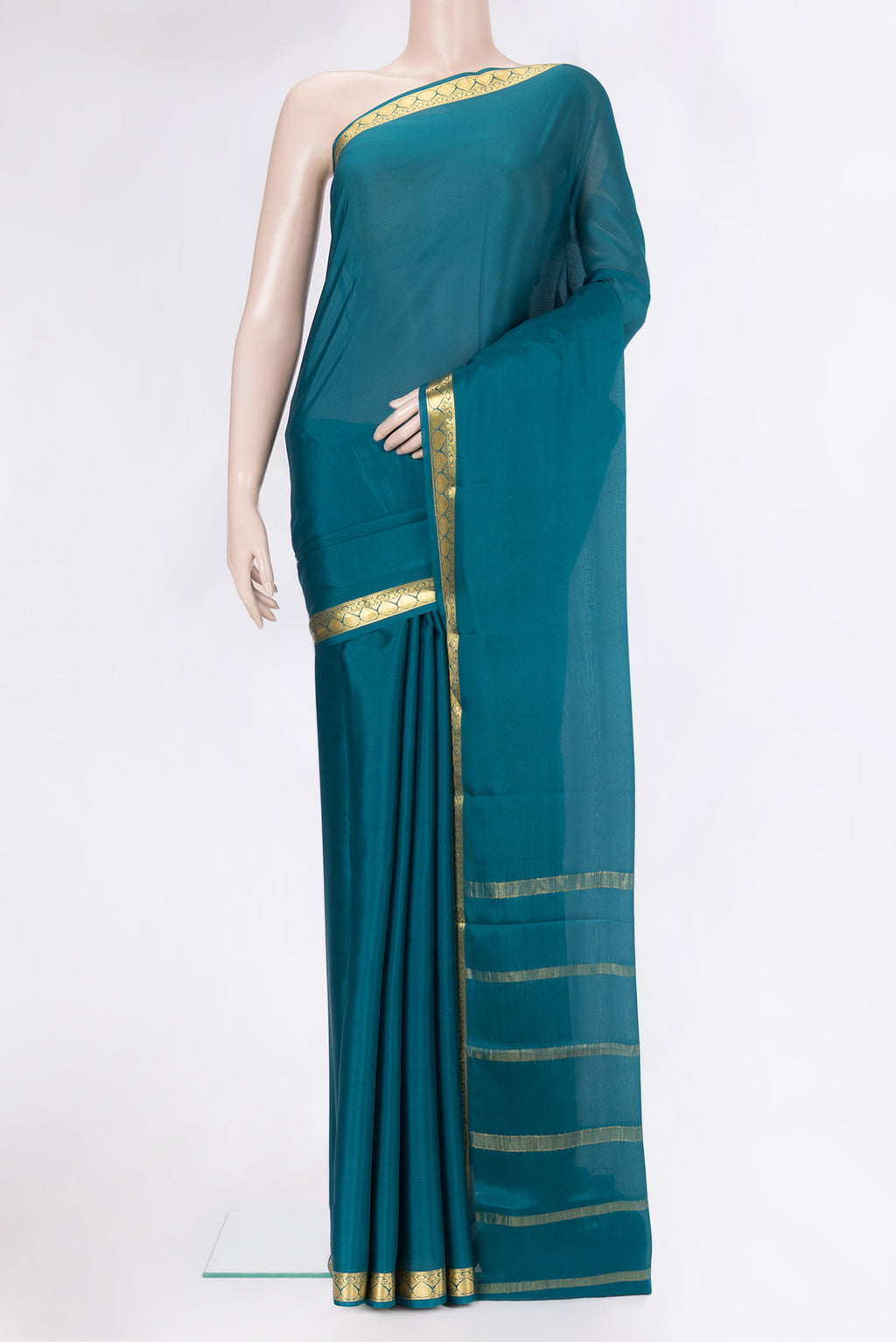 Peacock Blue Mysore Silk Saree with Plain Body and Zari Border.  displayed on a mannequin