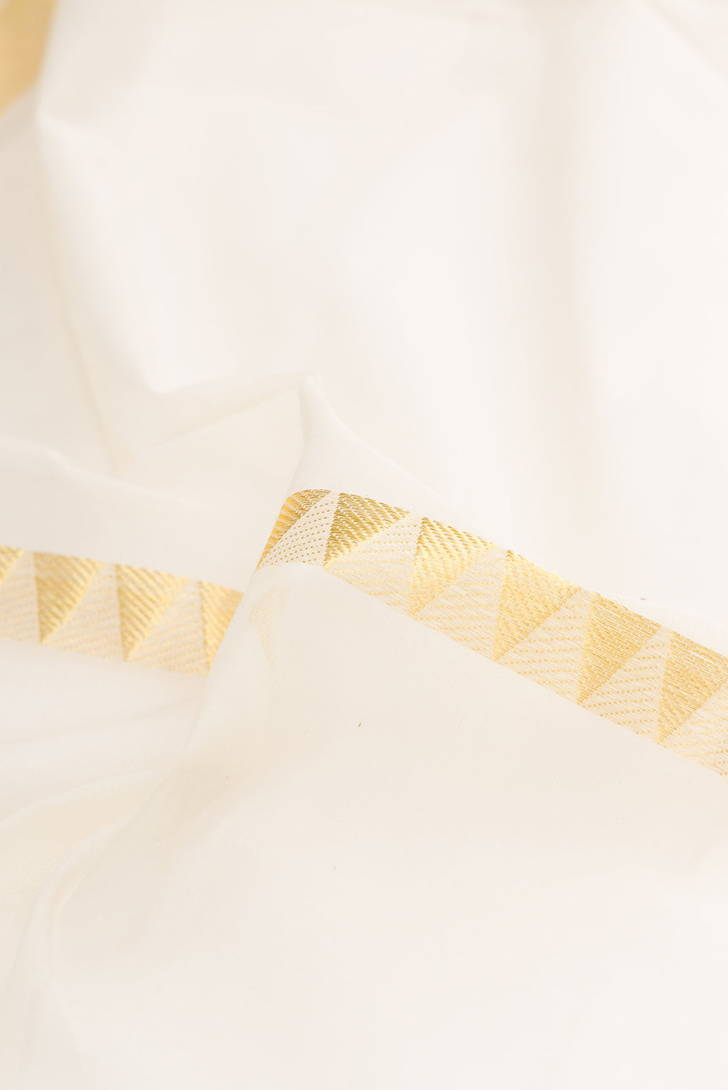 Close up of Pure Silk Off White Kerala Cotton Saree with Stripes on the body and Zari Border.  displaying folds