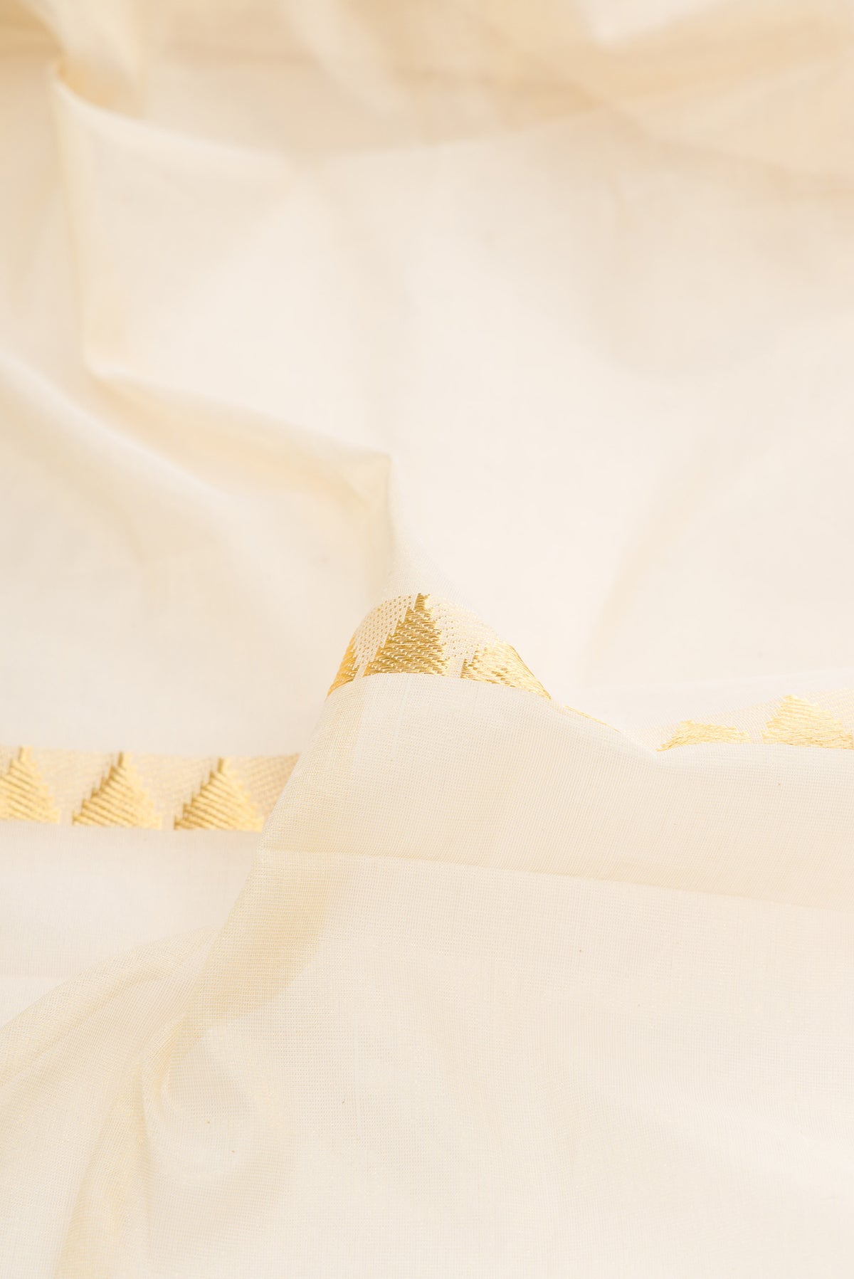 Close up of Pure Silk Off White Kerala Cotton Saree with Stripes on the body and Zari Border.  displaying folds
