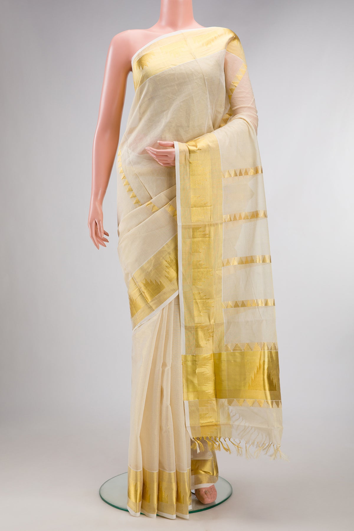 Pure Silk Off White Kerala Cotton Saree with Stripes on the body and Zari Border.  displayed on a mannequin