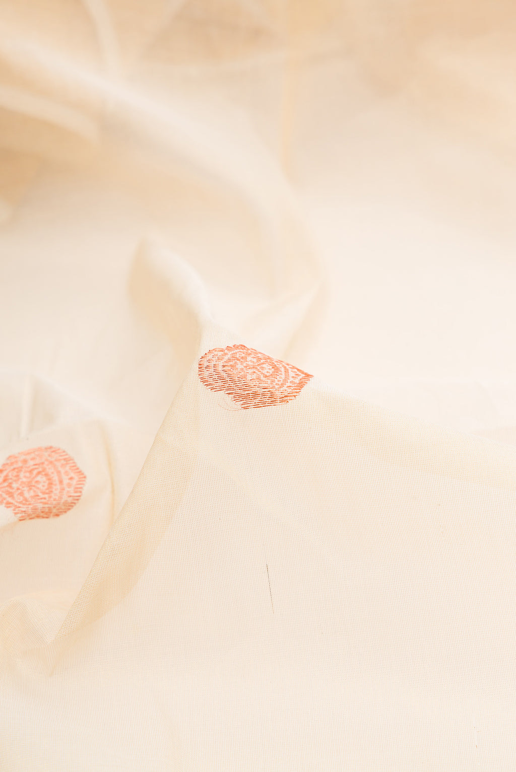 Close up of Pure Silk Off White Kerala Cotton Saree with Zari Butta on the body and Fancy Border.  displaying folds