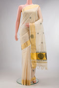 Pure Silk Off White Kerala Cotton Saree with Thread Butta on the body and Zari Border.  displayed on a mannequin