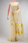 Off White Kerala Cotton Saree with Zari Butta on the body and Zari Border.  displayed on a mannequin