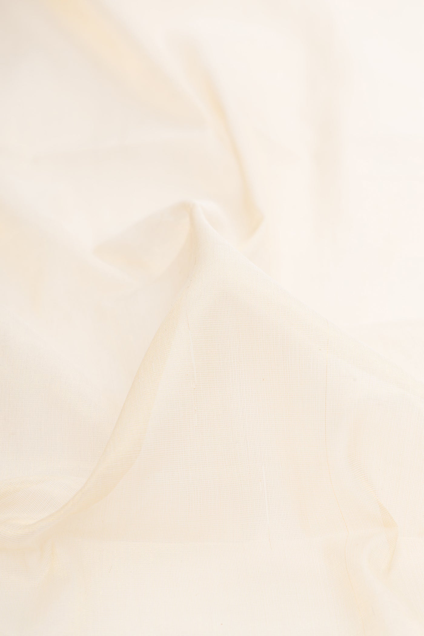 Close up of Off White Kerala Cotton Saree with Plain Body and Temple Border.  displaying folds