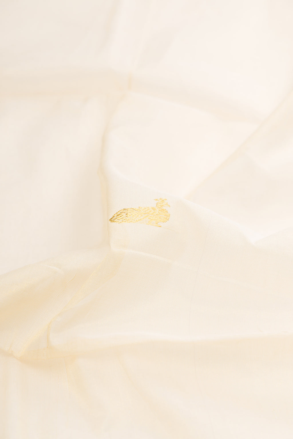 Close up of Pure Silk Off White Kerala Cotton Saree with Zari Butta on the body and Zari Border.  displaying folds