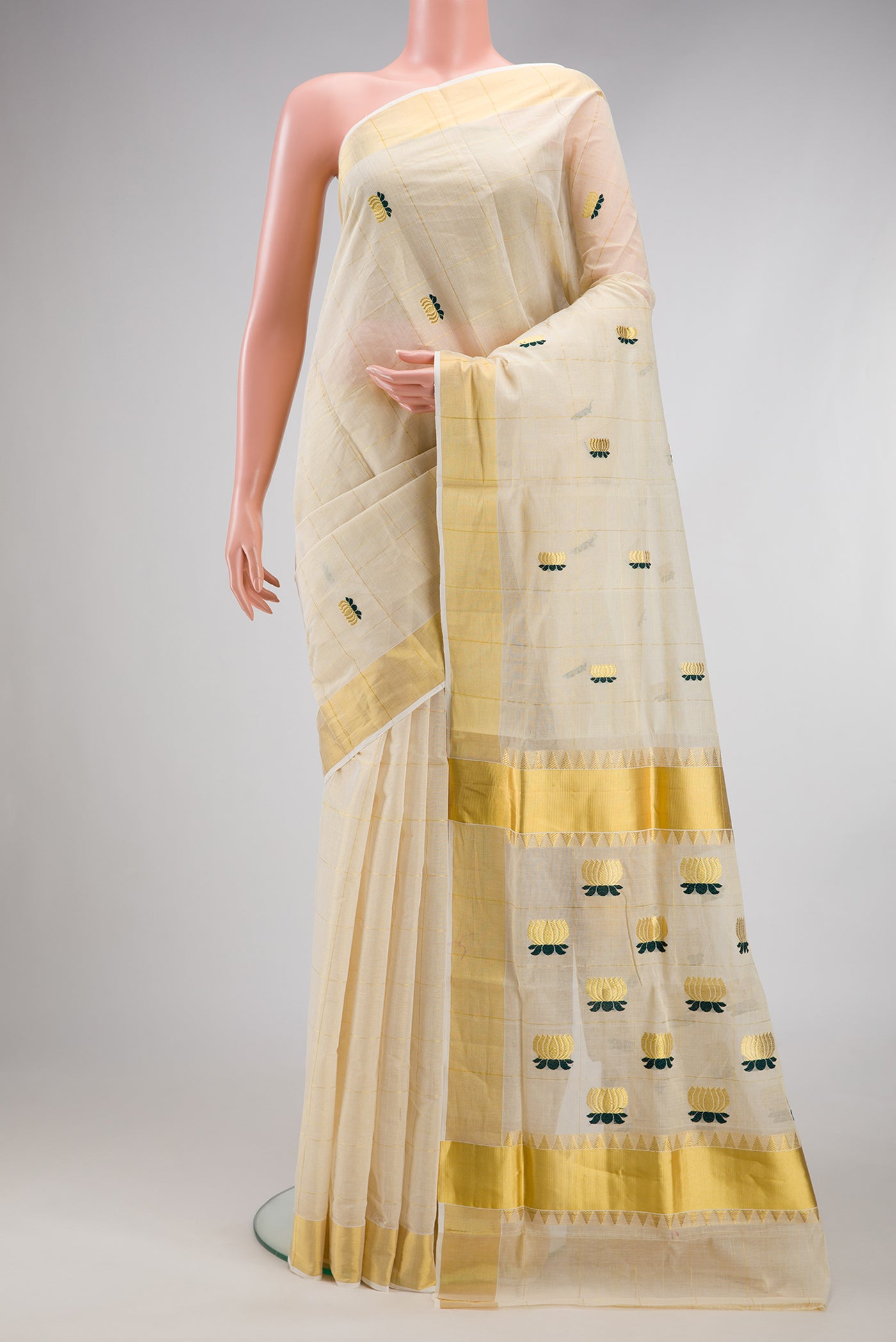Off White Kerala Cotton Saree with Checked design on the body and Zari Border.  displayed on a mannequin