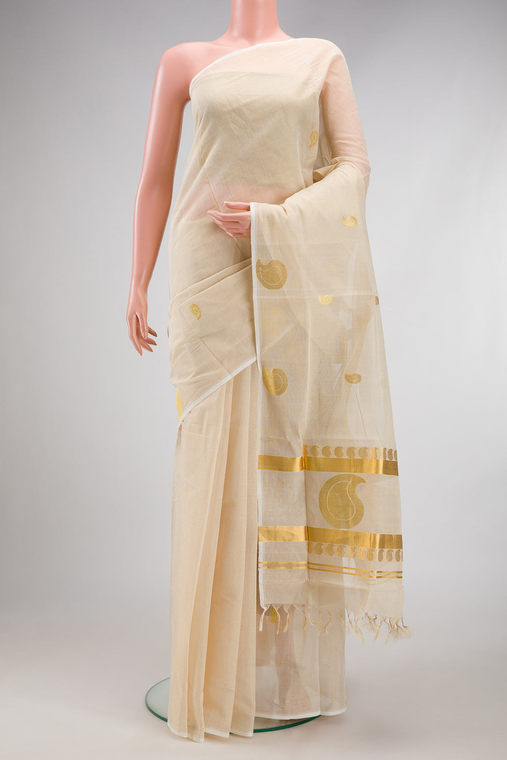 Off White Kerala Cotton Saree with Zari Butta on the body and Without Border.  displayed on a mannequin