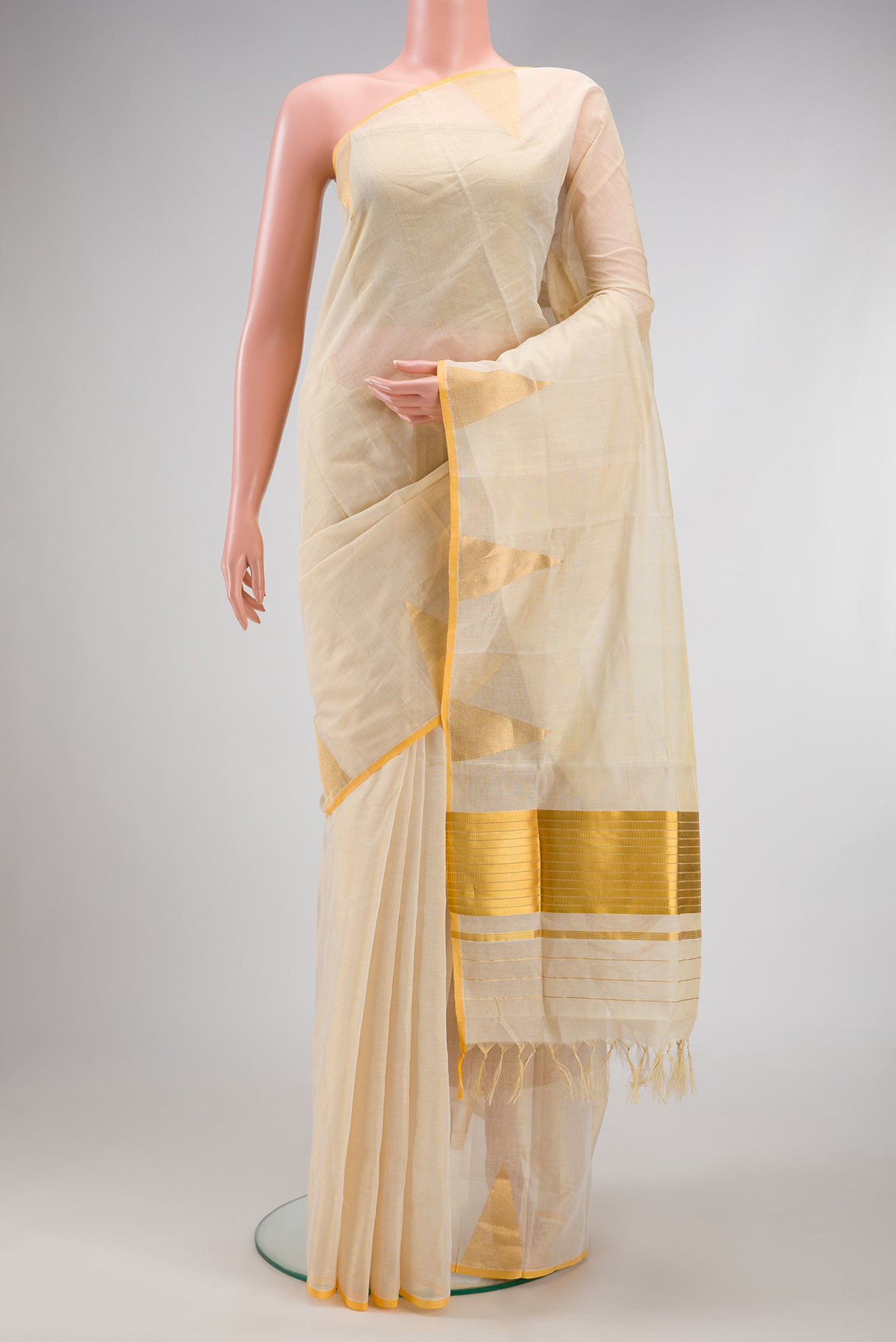 Off White Kerala Cotton Saree with Plain Body and Temple Border.  displayed on a mannequin