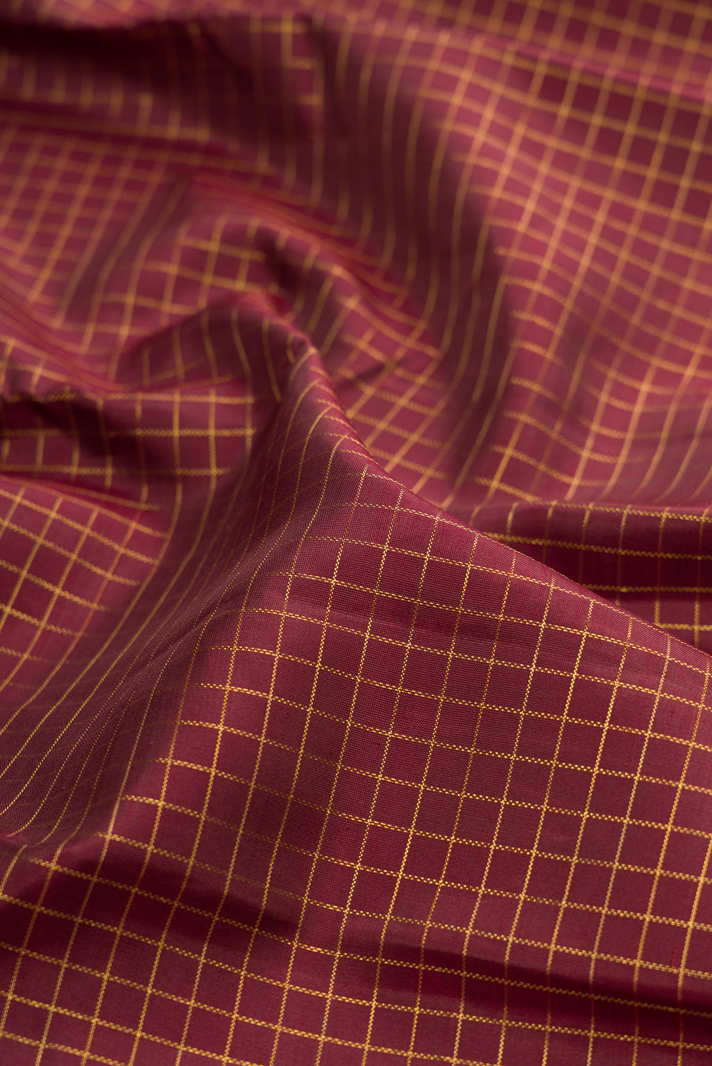 Close up of Pure Silk Pure Zari Coffee Brown Kanchipuram Saree with Checked design on the body and Fancy Border.  displaying folds