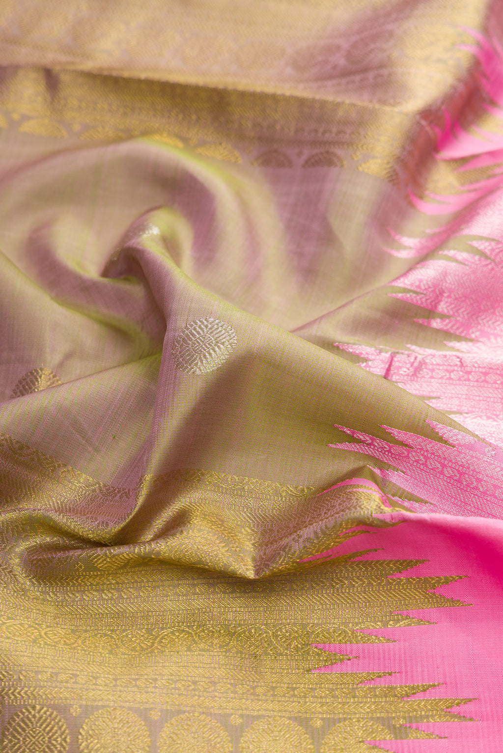 Close up of Pure Silk Pure Zari Pink Dual Tone Kanchipuram Saree with Stripes on the body and Fancy Border.  displaying folds