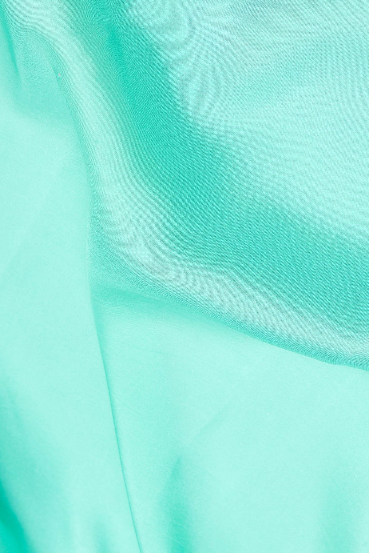 Close up of Pure Silk Pure Zari Sea Green Mysore Silk Saree with Plain Body and Zari Border.  displaying folds