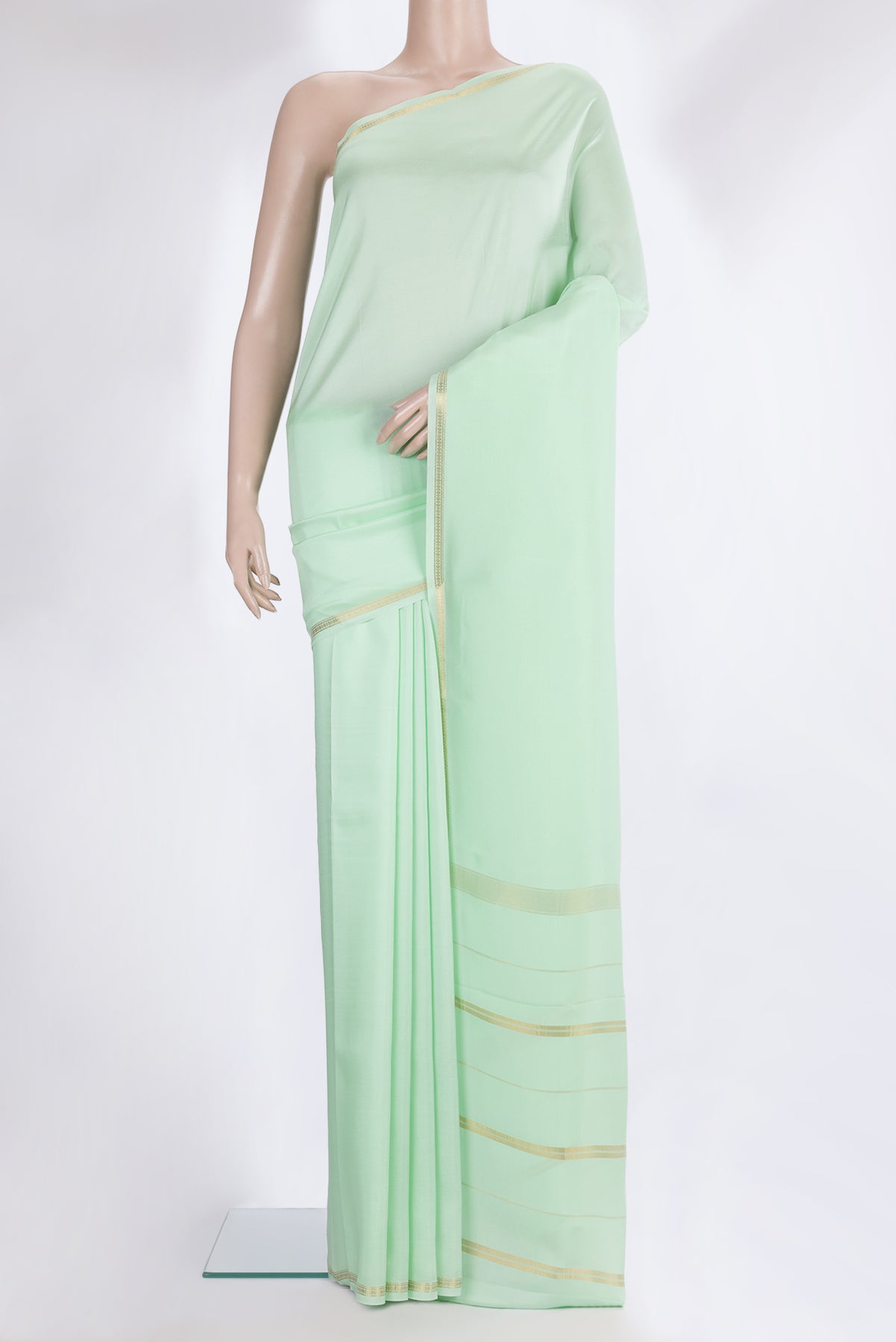 Pure Silk Pure Zari Pista Green Mysore Silk Saree with Plain Body and Zari Border.  displayed on a mannequin