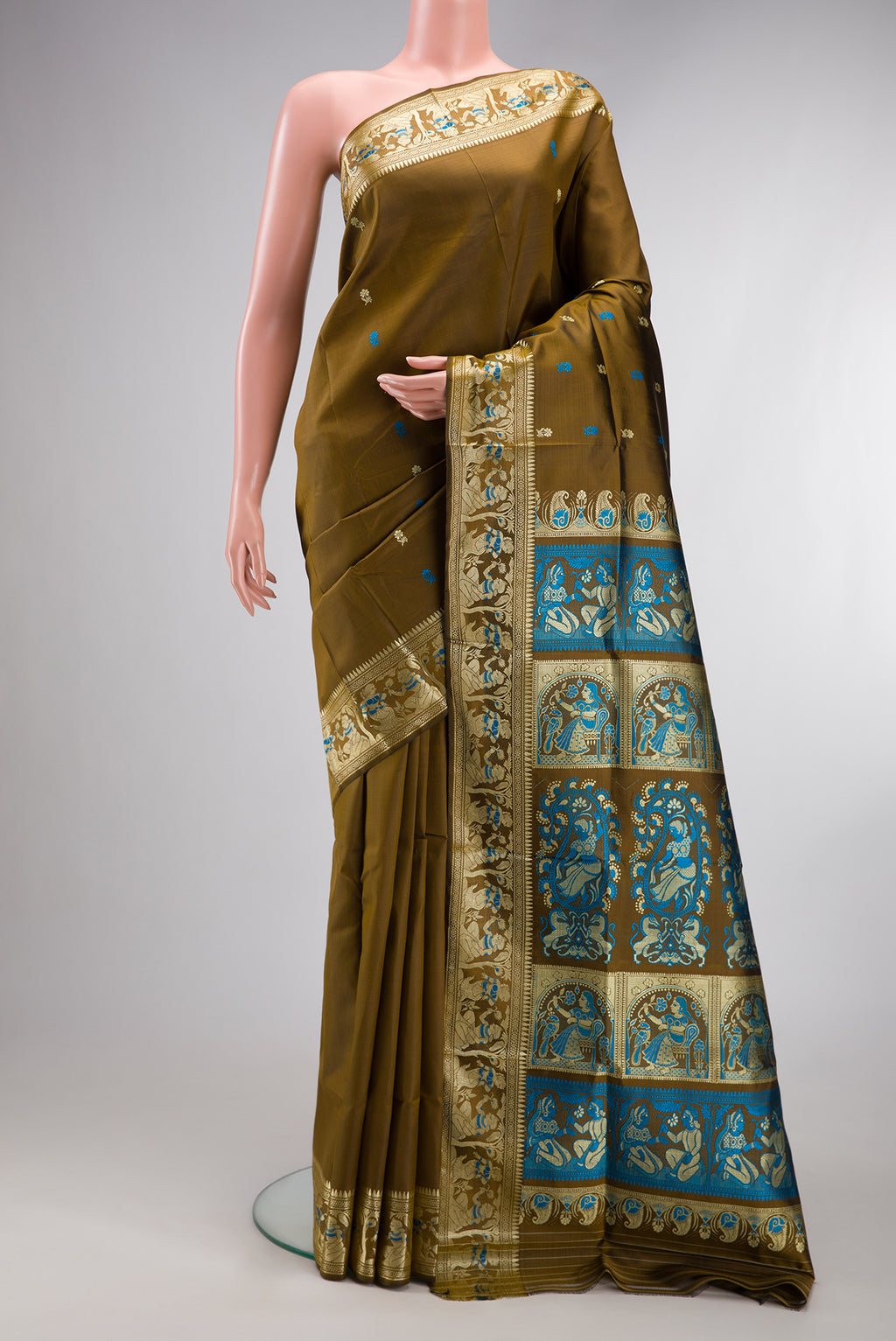 Mehandi Green Baluchari Silk Saree with Thread Butta on the body and Thread Border.  displayed on a mannequin