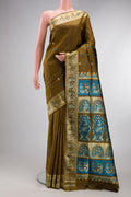 Mehandi Green Baluchari Silk Saree with Thread Butta on the body and Thread Border.  displayed on a mannequin
