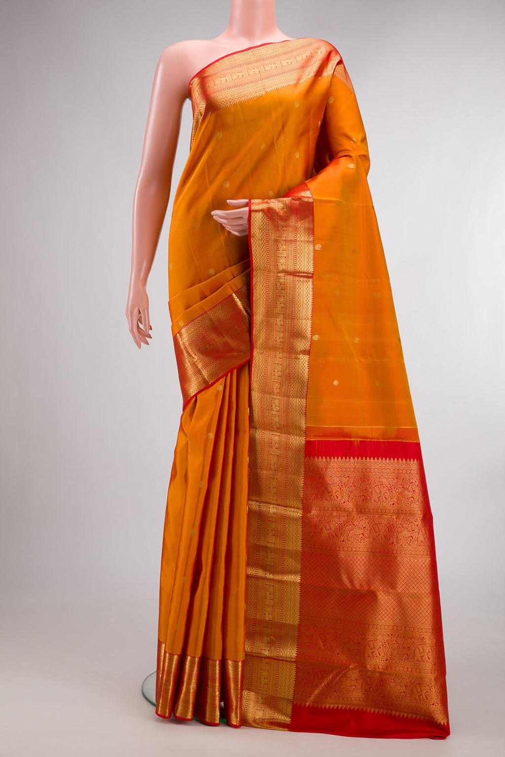 Pure Silk Mustard Dual Tone Kanjivaram Saree with Zari Butta on the body and Zari Border.  displayed on a mannequin