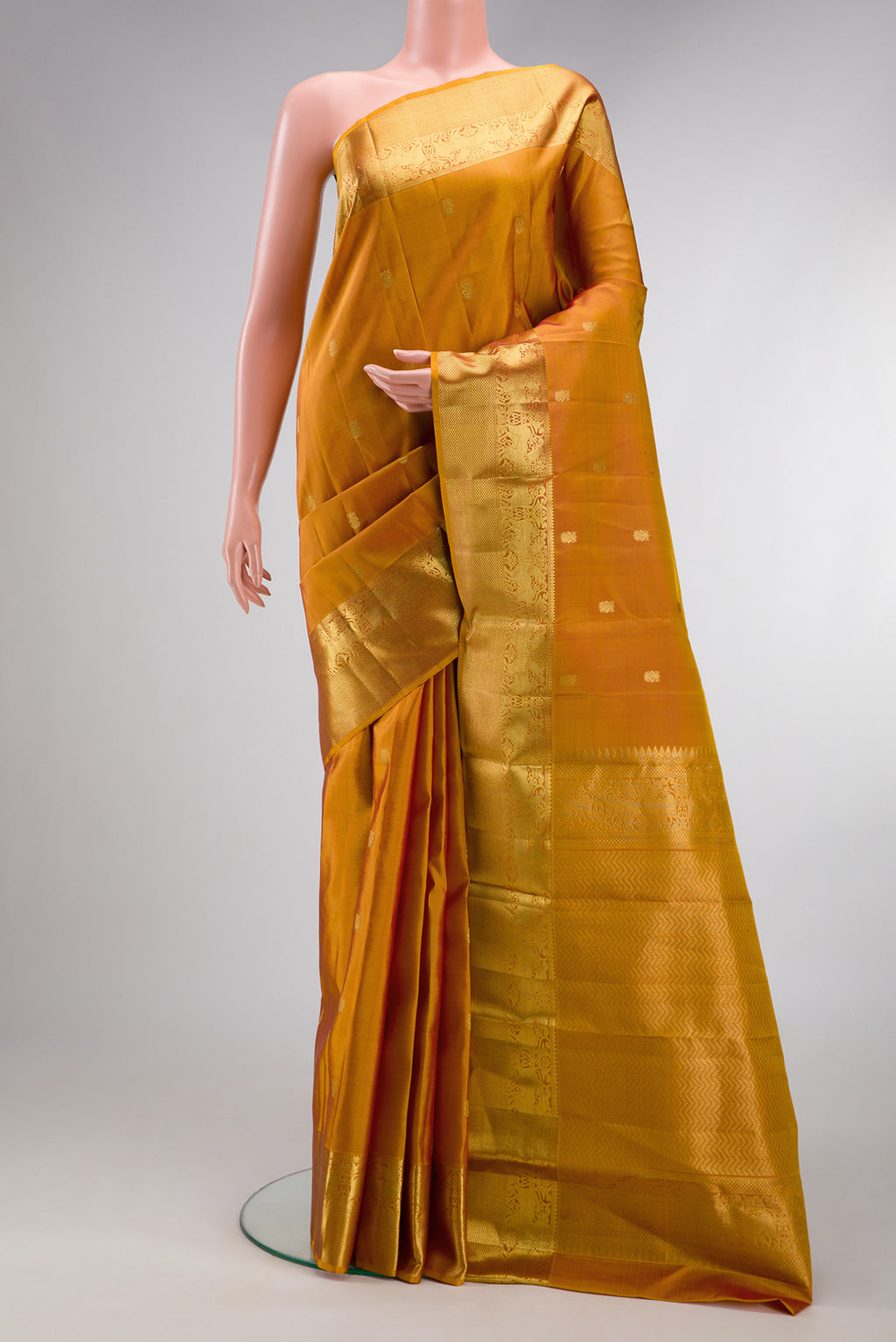 Mustard Dual Tone Kanjivaram Silk Saree with Zari Butta on the body and Zari Border.  displayed on a mannequin