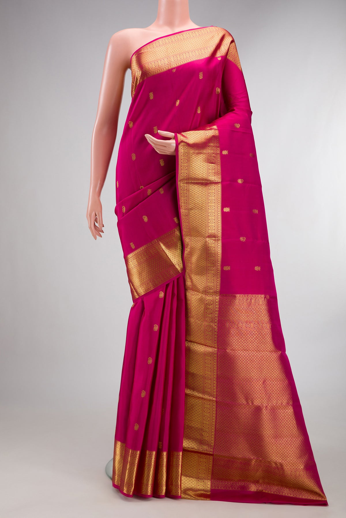 Pure Silk Pink Kanjivaram Saree with Zari Butta on the body and Zari Border.  displayed on a mannequin