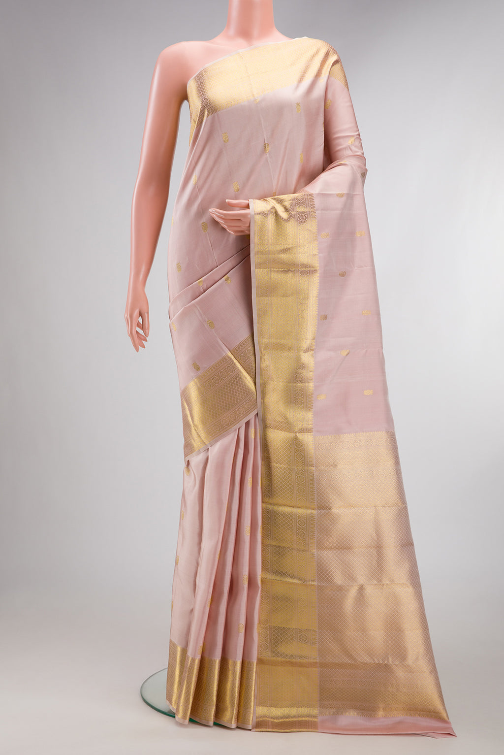 Pure Silk Rose pink Kanjivaram Saree with Zari Butta on the body and Zari Border.  displayed on a mannequin