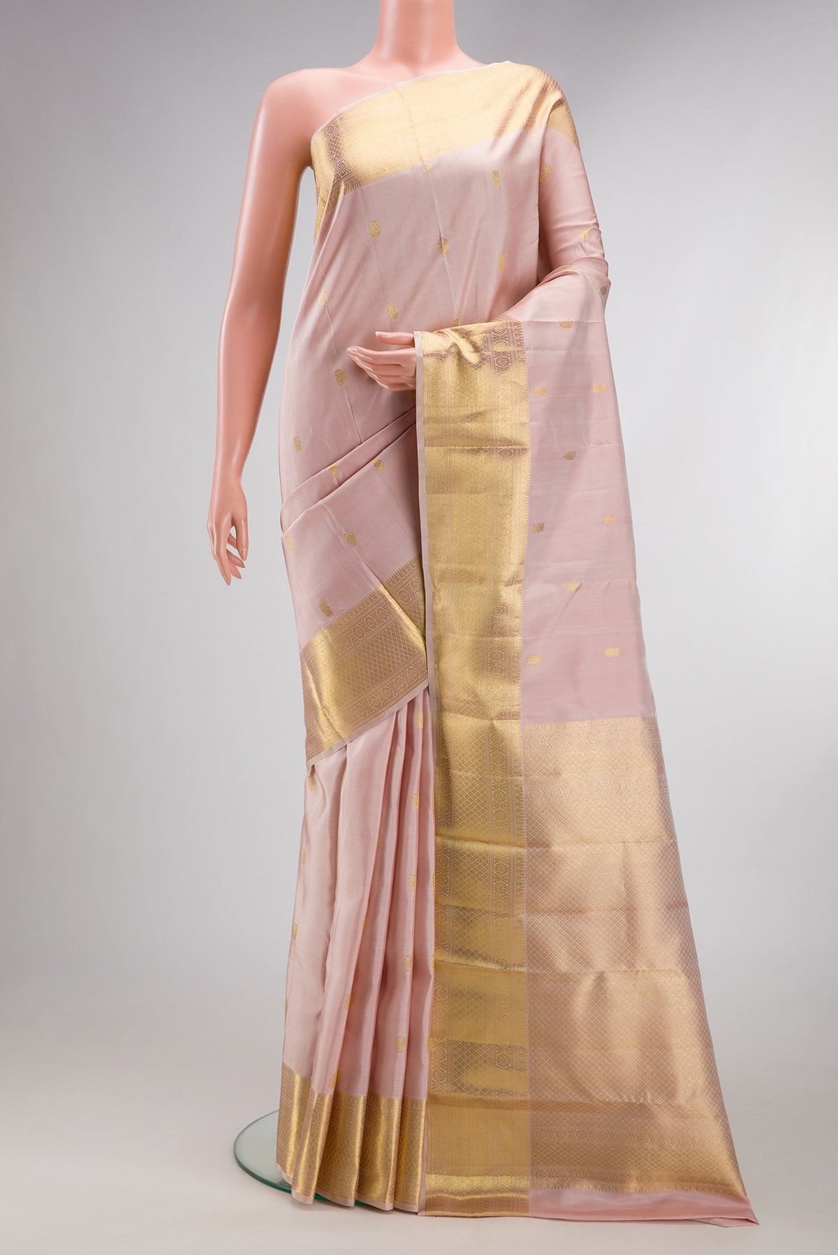 Pure Silk Rose pink Kanjivaram Saree with Zari Butta on the body and Zari Border.  displayed on a mannequin
