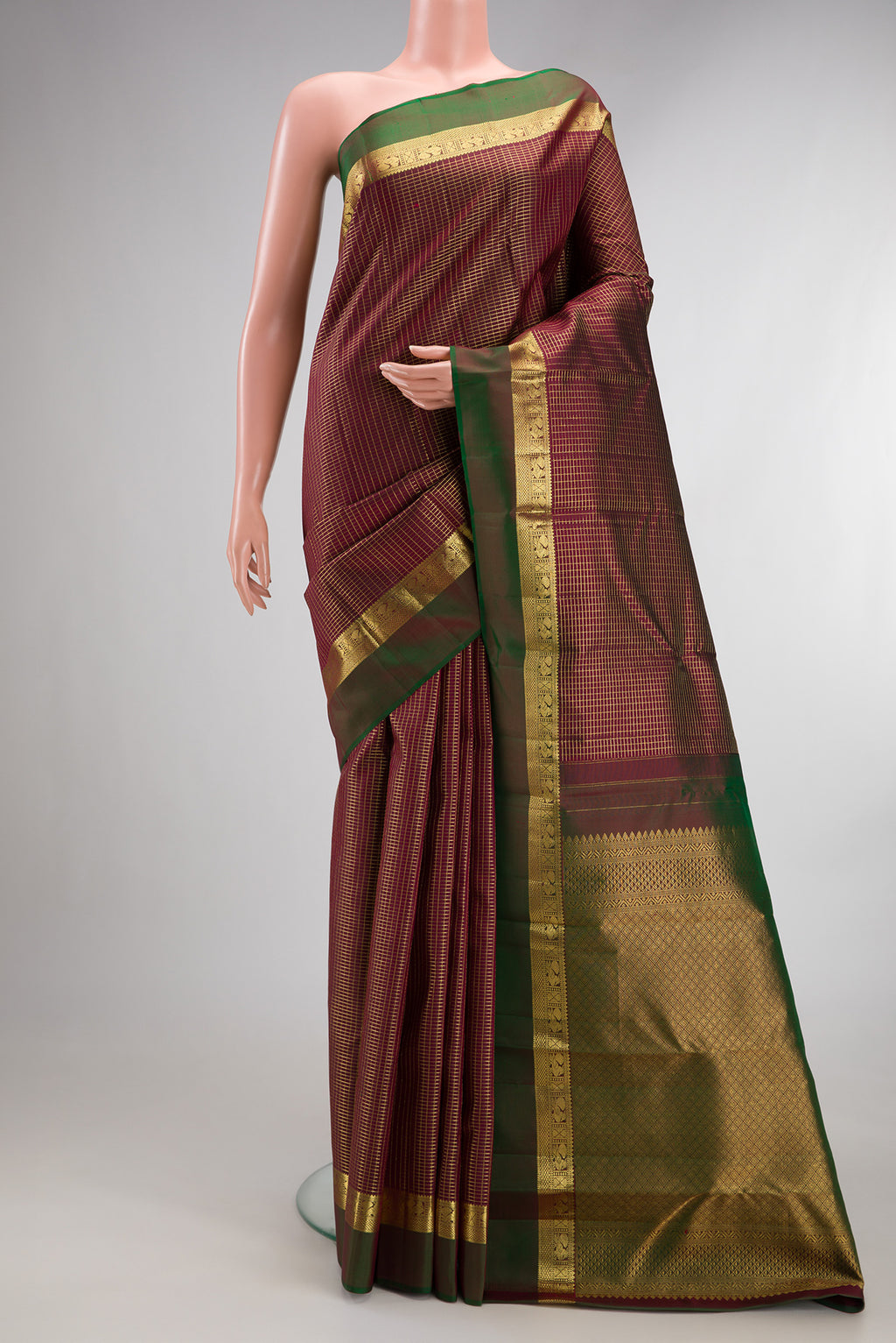 Pure Silk Maroon Kanchipuram Saree with Checked design on the body and Zari Border.  displayed on a mannequin
