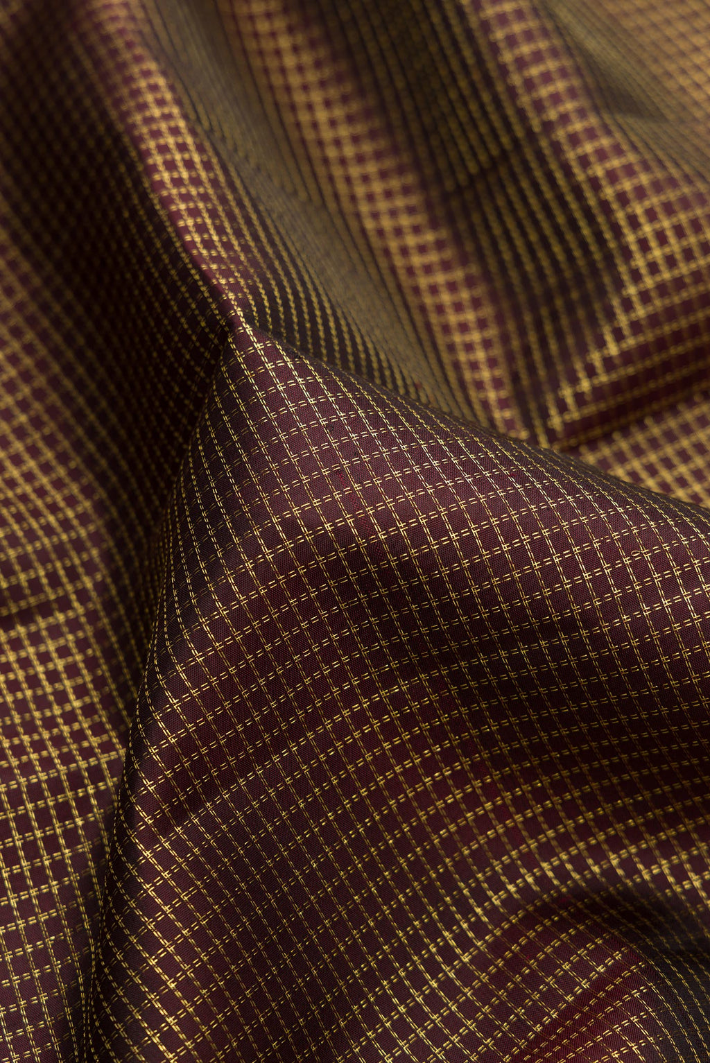 Close up of Pure Silk Coffee Brown Kanchipuram Saree with Checked design on the body and Zari Border.  displaying folds