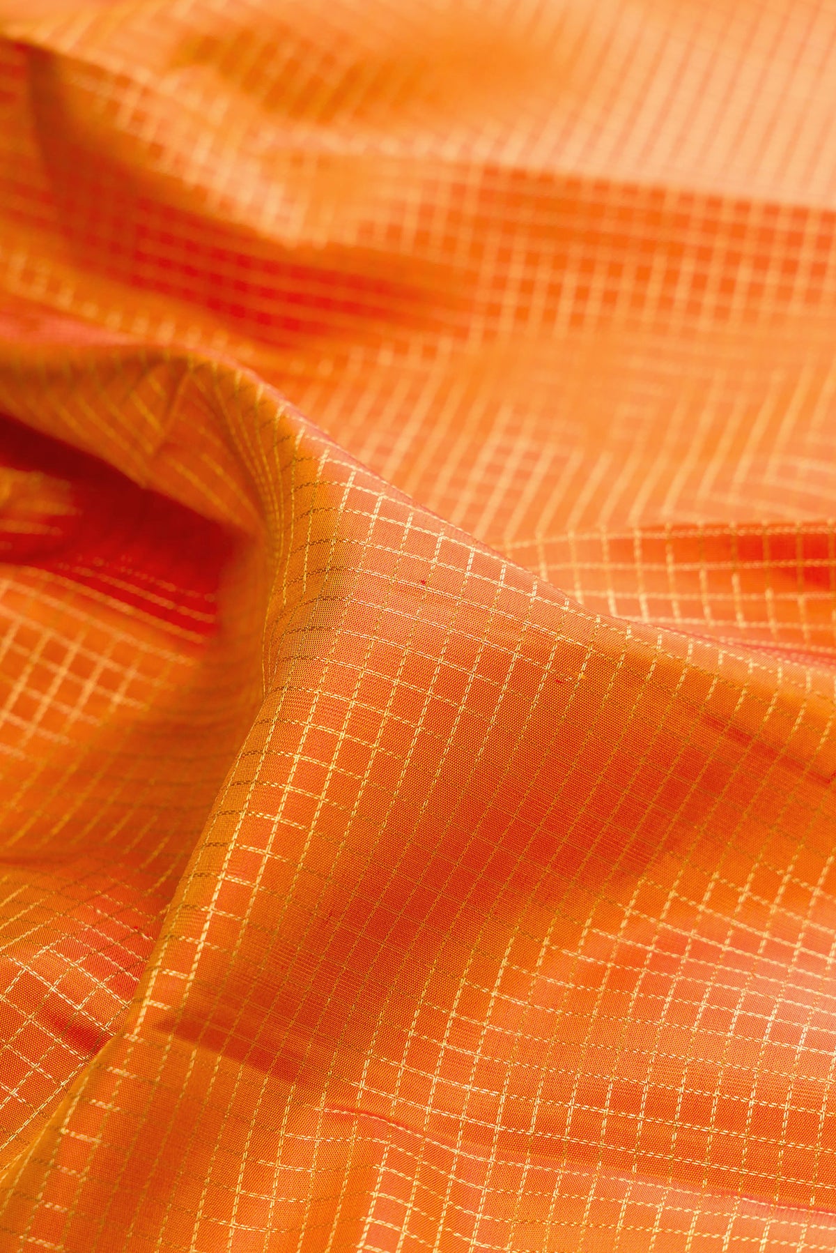 Close up of Pure Silk Mustard Dual Tone Kanchipuram Saree with Checked design on the body and Zari Border.  displaying folds