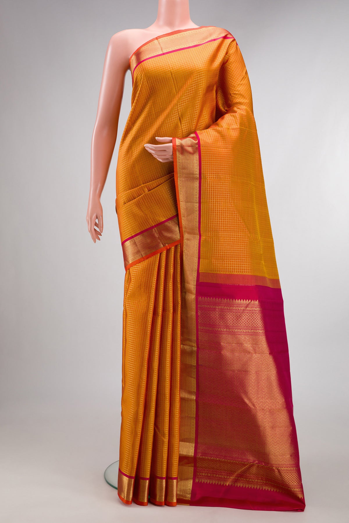 Pure Silk Mustard Dual Tone Kanchipuram Saree with Checked design on the body and Zari Border.  displayed on a mannequin
