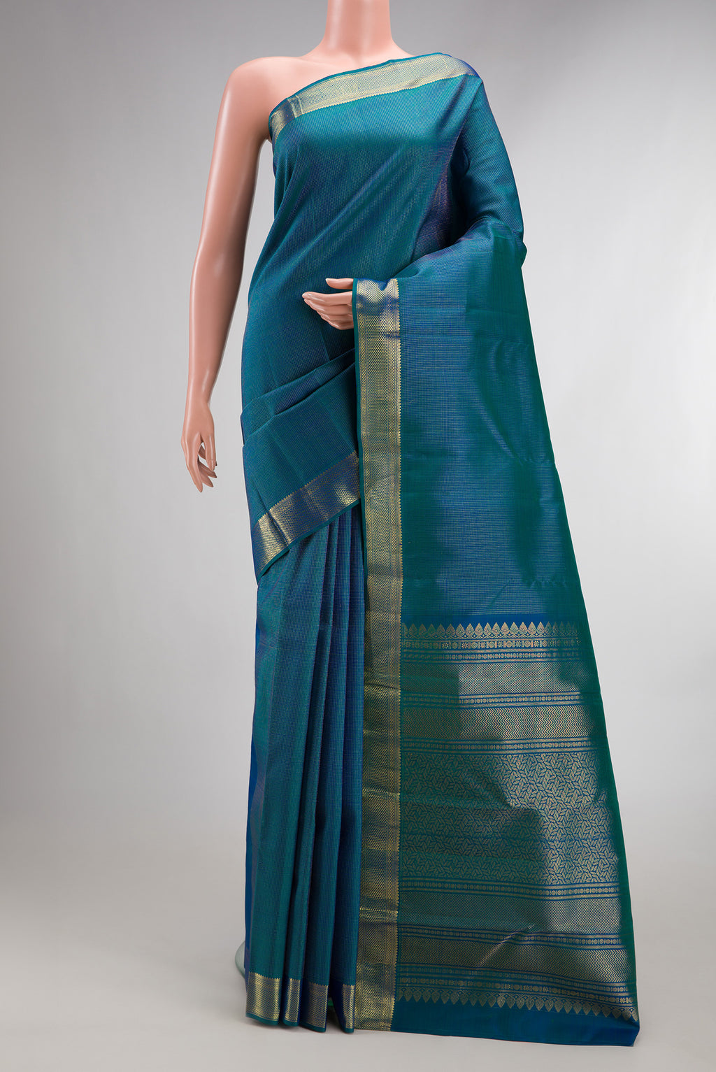 Pure Silk Peacock Blue Dual Tone Kanchipuram Saree with Checked design on the body and Zari Border.  displayed on a mannequin