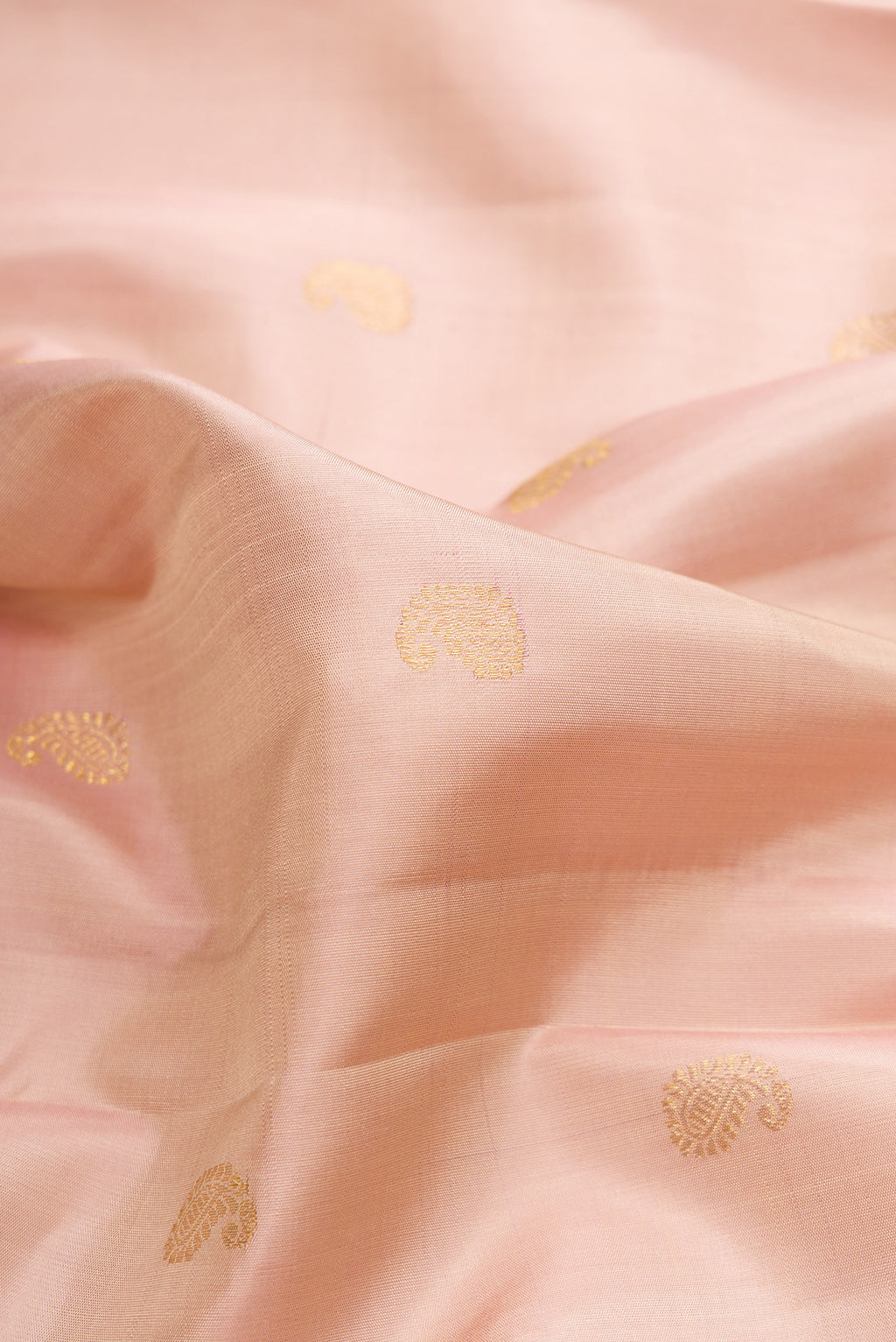 Close up of Pure Silk Sandal Kanchipuram Saree with Zari Butta on the body and Zari Border.  displaying folds